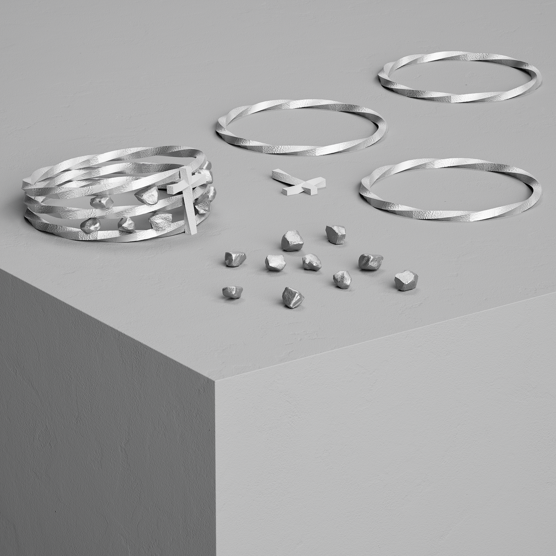 Anneaux en métal argenté suspendus au plafond, avec petits morceaux de métal autour, dans un style minimaliste et monochrome.