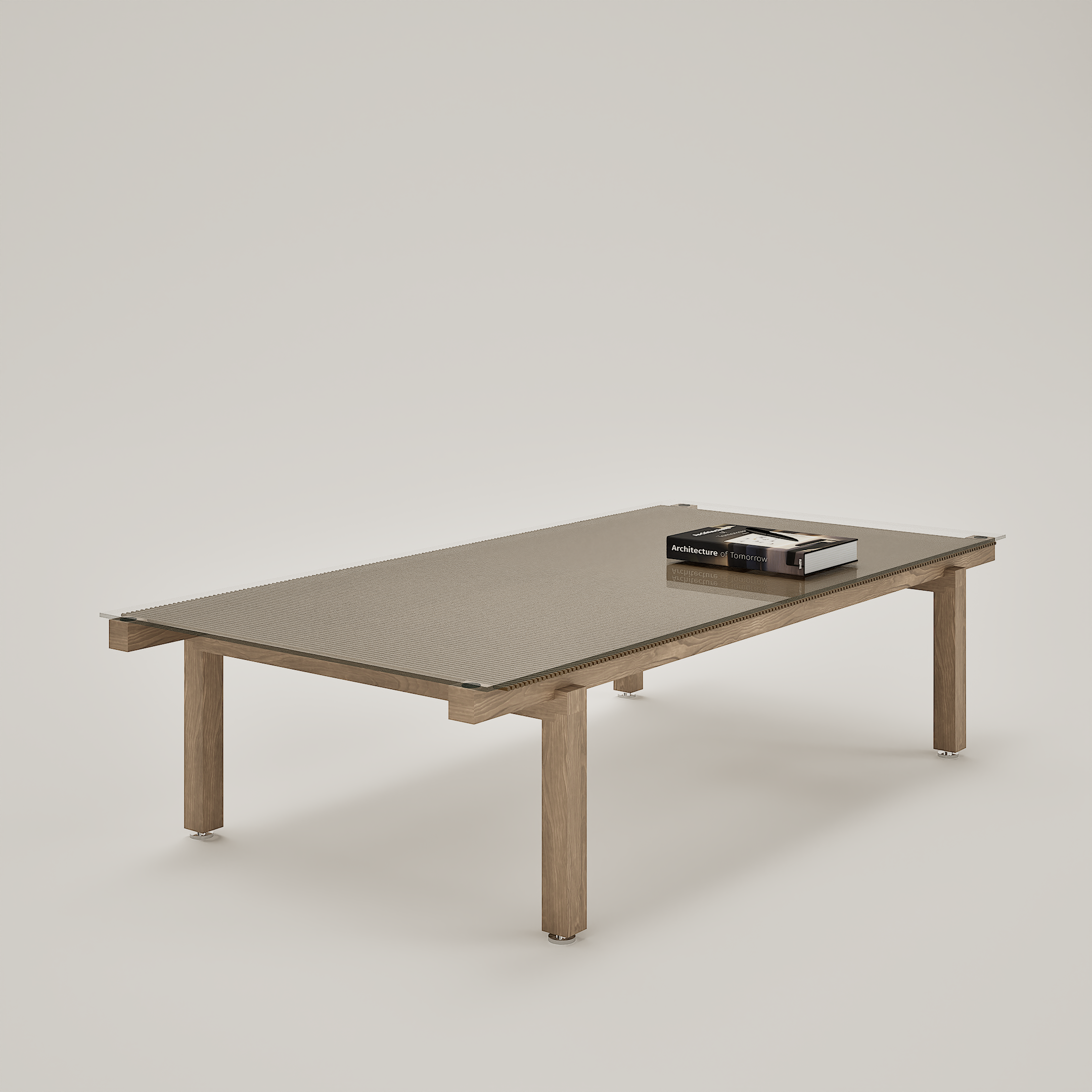 Table en bois avec un livre intitulé 'Architecture of Tomorrow' posée dessus, dans un espace minimaliste avec un mur blanc en arrière-plan.