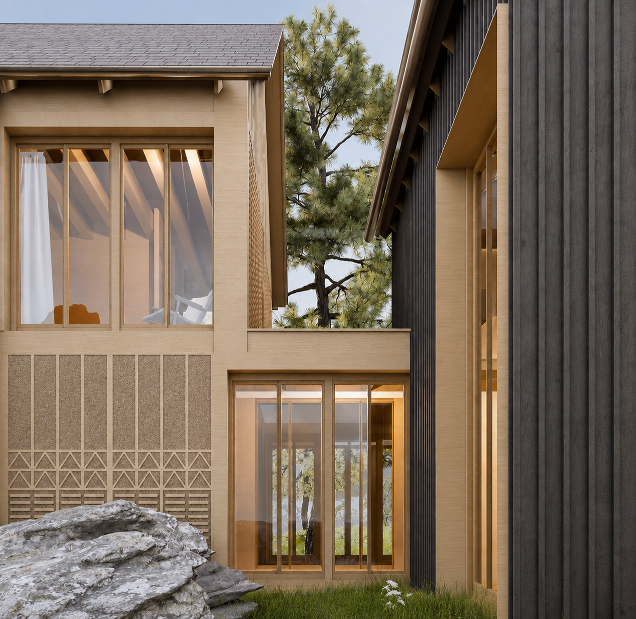 Vue d'une maison moderne avec un mélange de matériaux en bois clair et sombre, de grandes fenêtres, et un arbre visible derrière. Il y a un tas de pierres ou débris au premier plan sur de l'herbe verte.