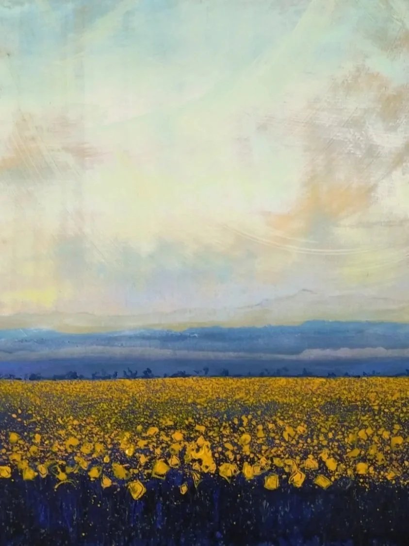 Painting of a vast field of yellow flowers with distant mountains and a cloudy sky.