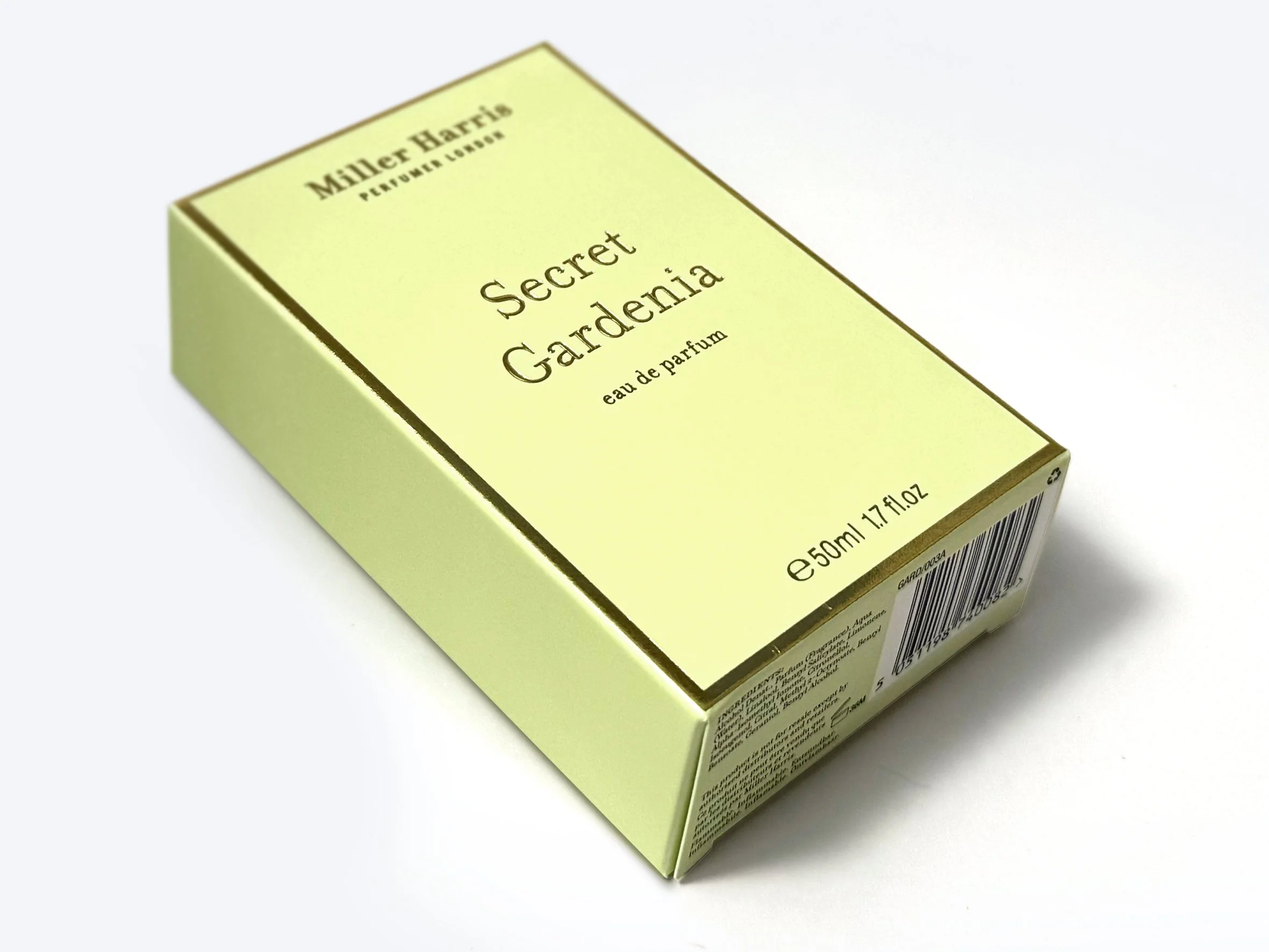 A pastel yellow box of Miller Harris perfume labeled "Secret Gardenia." Miller Harris carton produced by Windles Packaging.