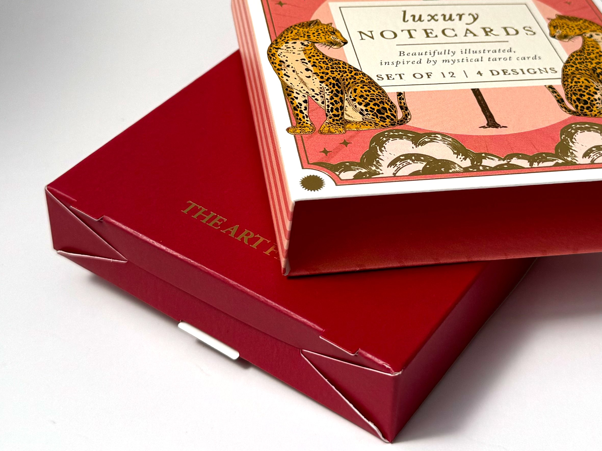 Close-up of a box of luxury notecards with illustrations of leopards on the packaging.