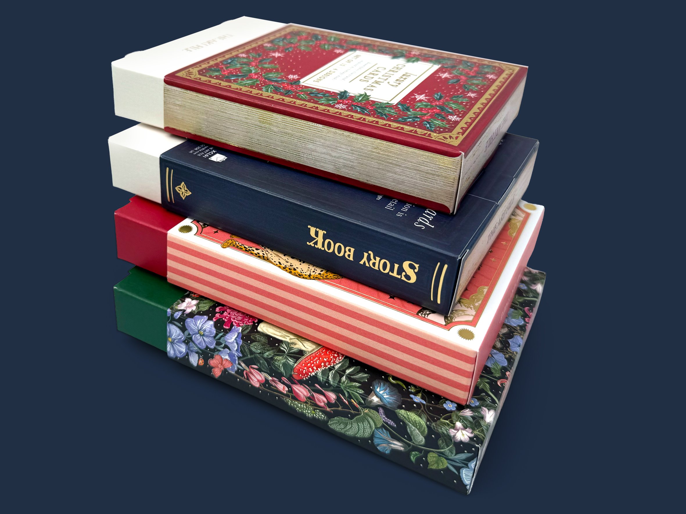 Stack of four decorative books with colorful, festive covers on a dark blue background.