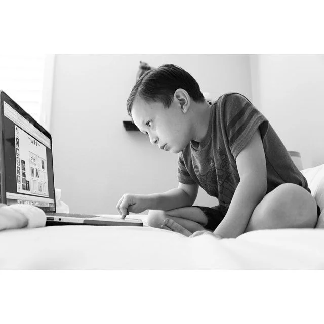 A Black and white photo of my nephew taken  while he was completely focused on the game online.  Photo taken in 2011