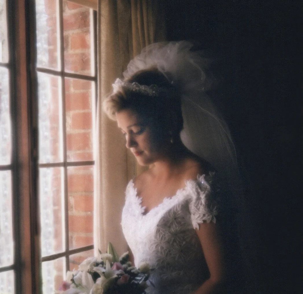 I took this Portrait in 1994. Location was a small town church in Yolo County, in Northern California
Note:  The room was dark...There was a small light outside the window.  I had the bride hold her breath for approximately 4 seconds to get the image