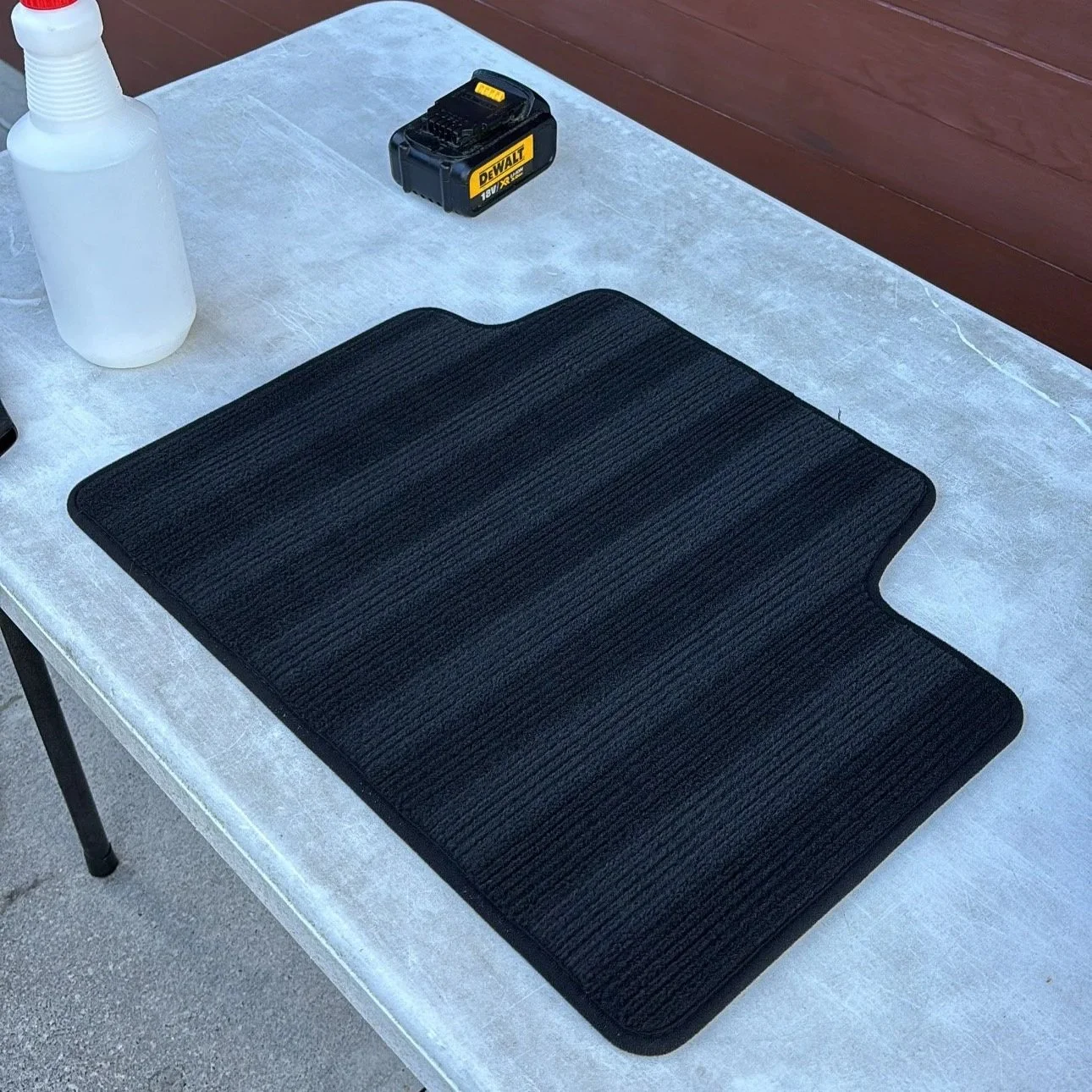 Deep-cleaned car floor mat after interior shampooing