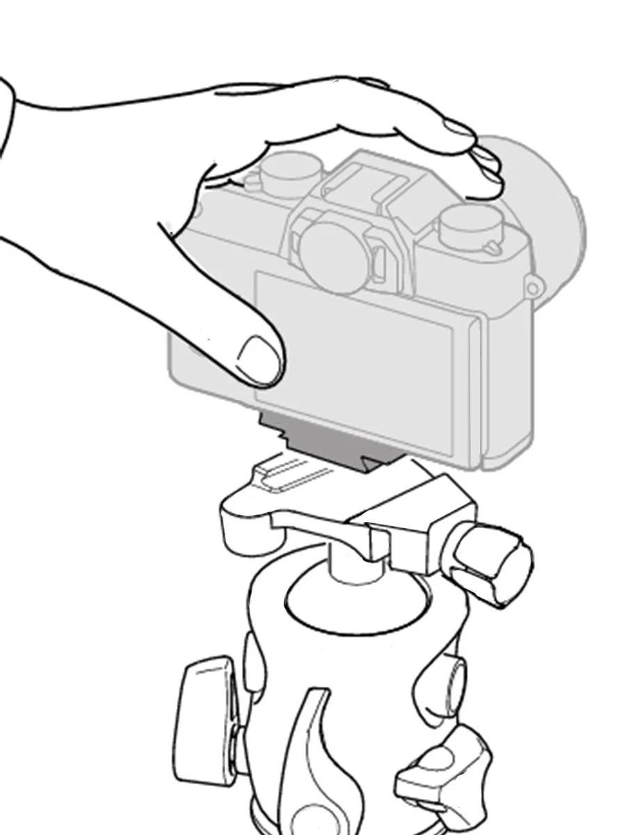 A hand adjusting or assembling a camera mounted on a tripod or stand.