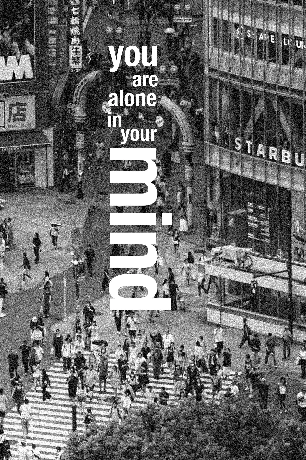 Black and white aerial view of a busy city street with many pedestrians crossing at a crosswalk, surrounded by tall buildings with signs and advertisements, including a Starbucks store and various billboards.