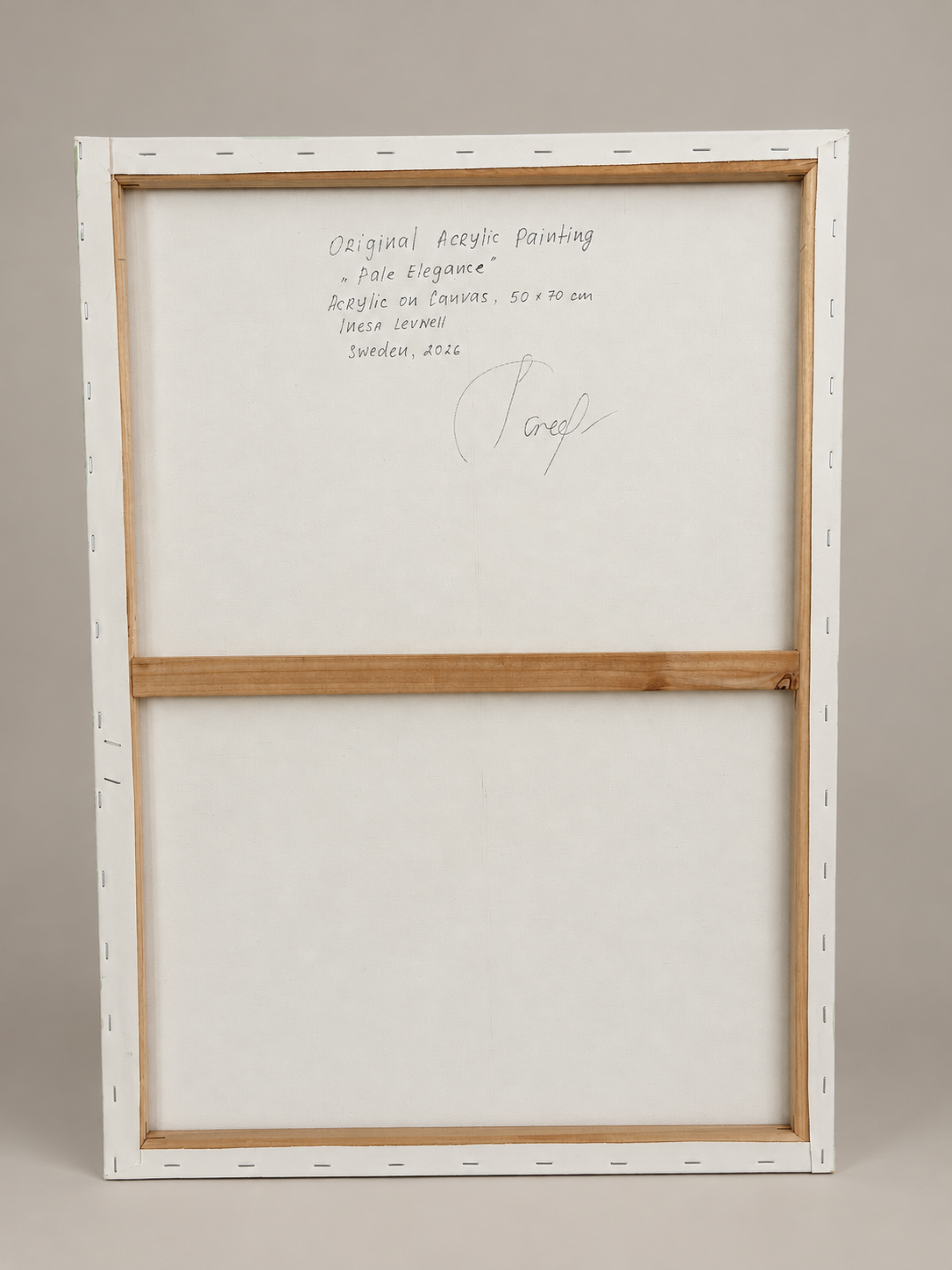 Back view of Pale Elegance, showing the original stretched canvas, wooden stretcher bars and handwritten artwork details.