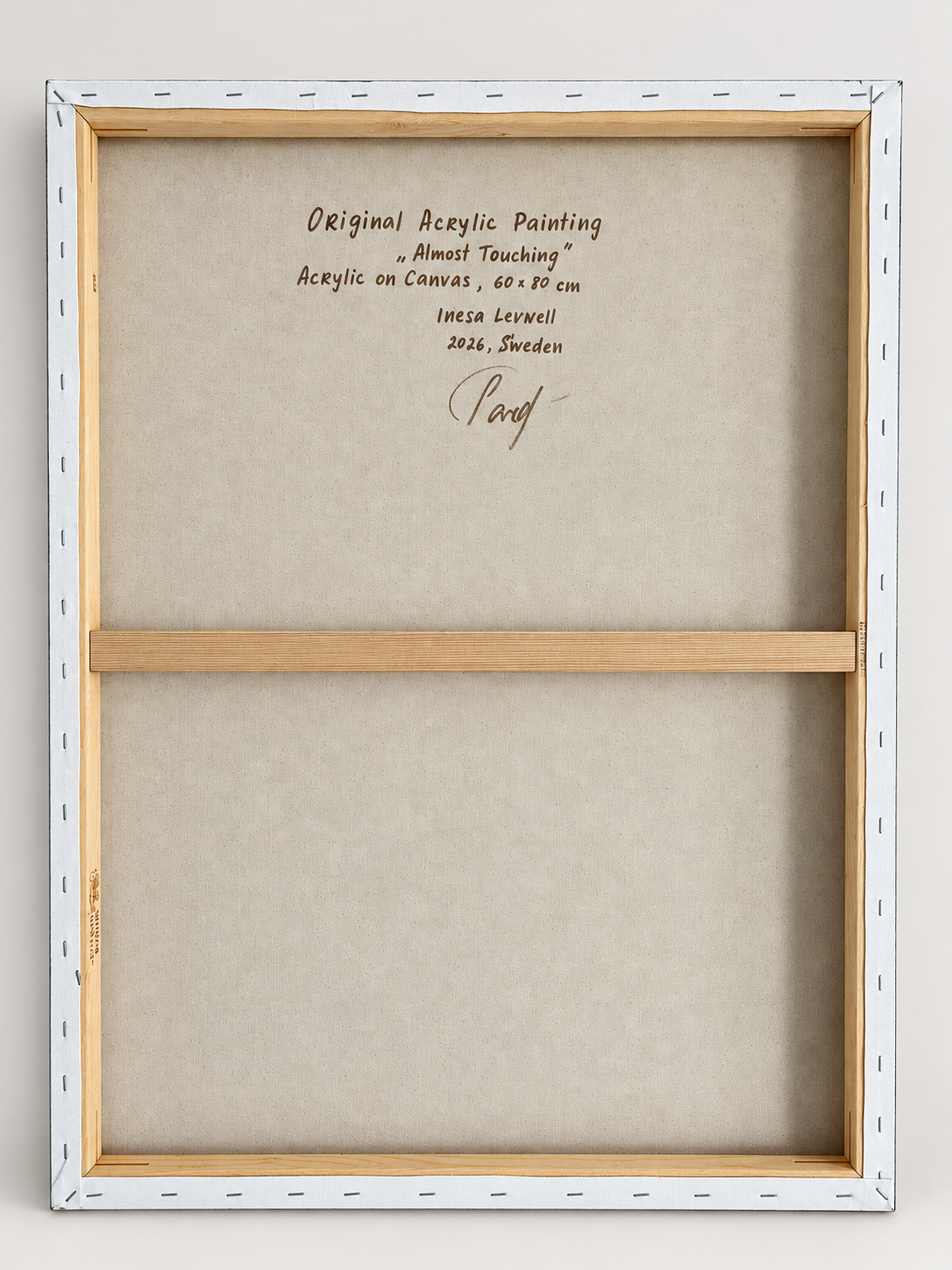 Back view of Almost Touching, showing the original stretched canvas, wooden stretcher bars and handwritten artwork details.