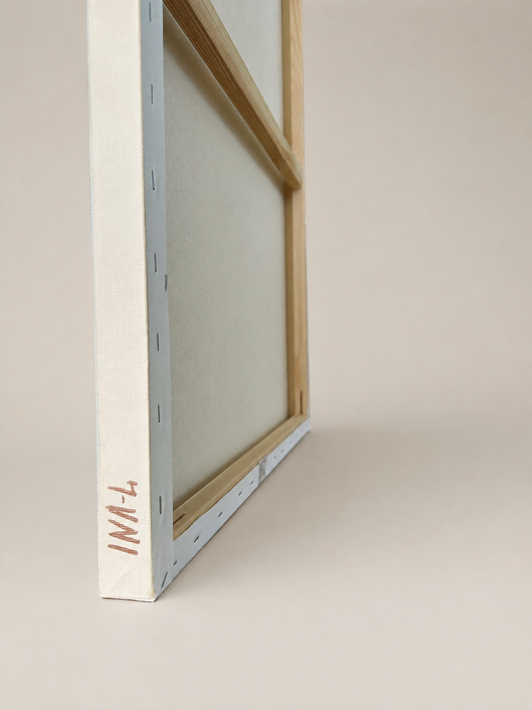 Side view of Held Bloom by Inesa Levnell, showing the gallery-wrapped canvas depth, painted edge and artist signature on the side.