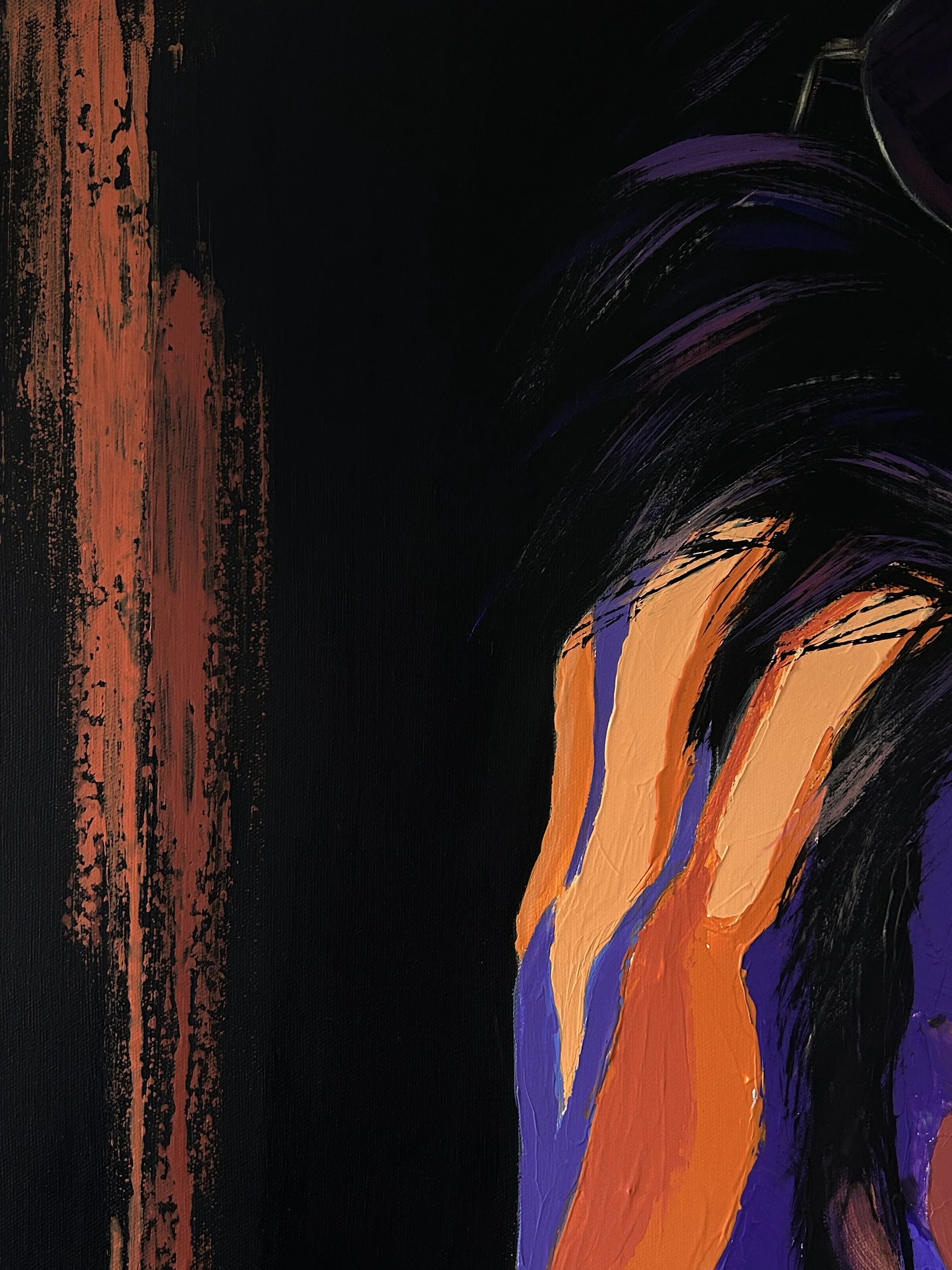 Close-up of Orange Static showing a vertical orange paint mark against the dark background beside the woman’s hair and hand.