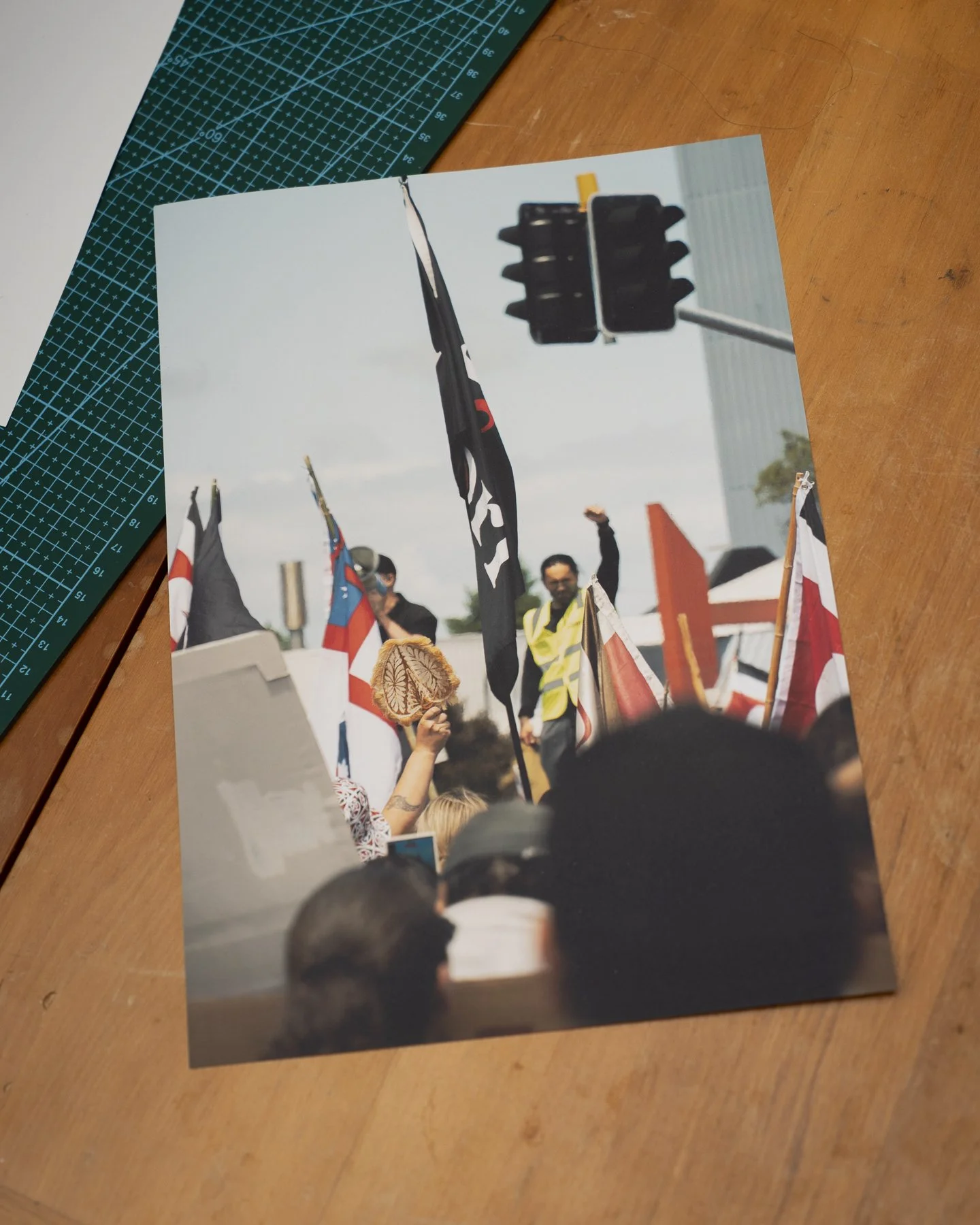 Photographic print of a speaker and participant holding up fists at the Hikoi across New Zealand