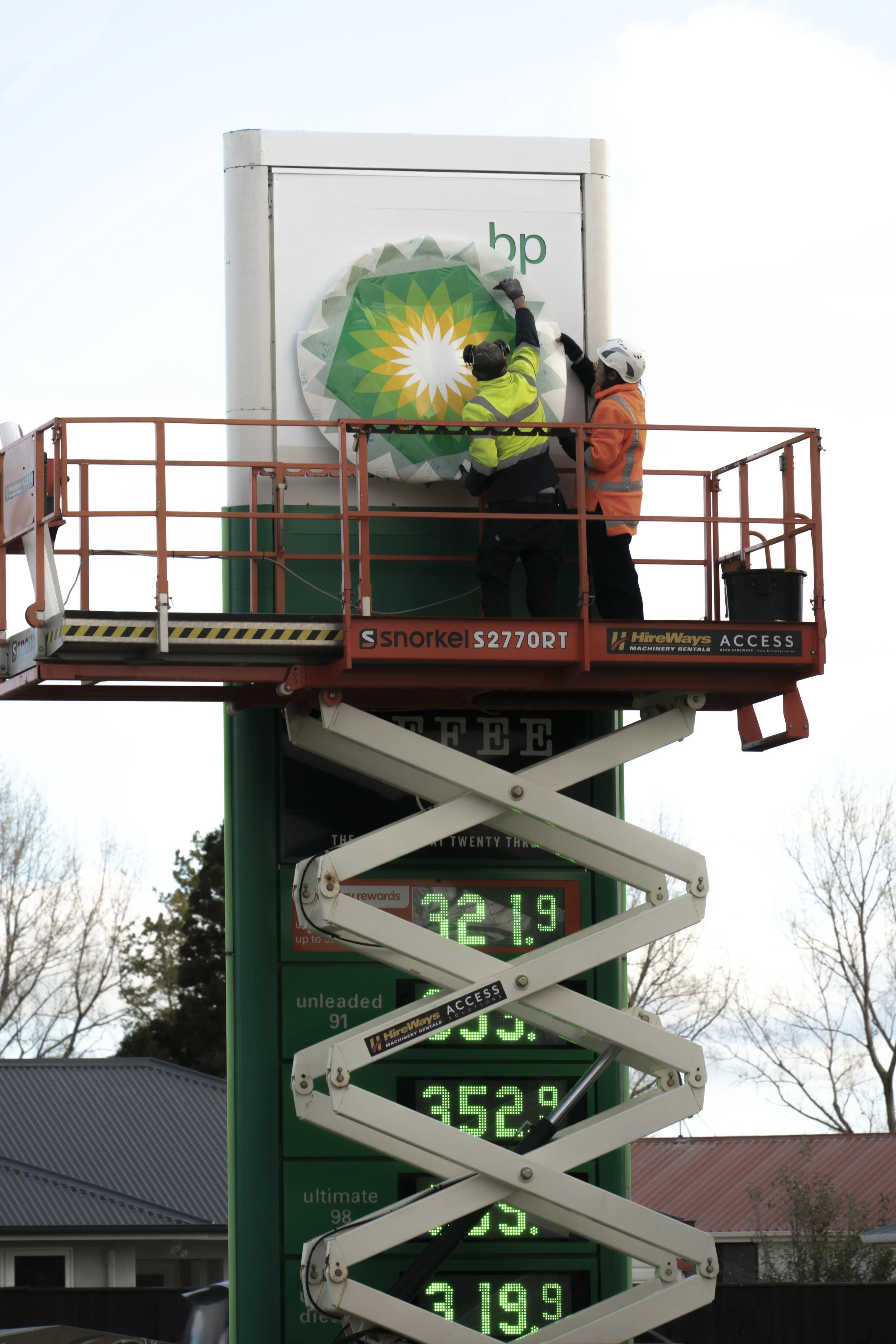 An example of Slice of Life Photography of Workers replacing a sign in Palmerston North