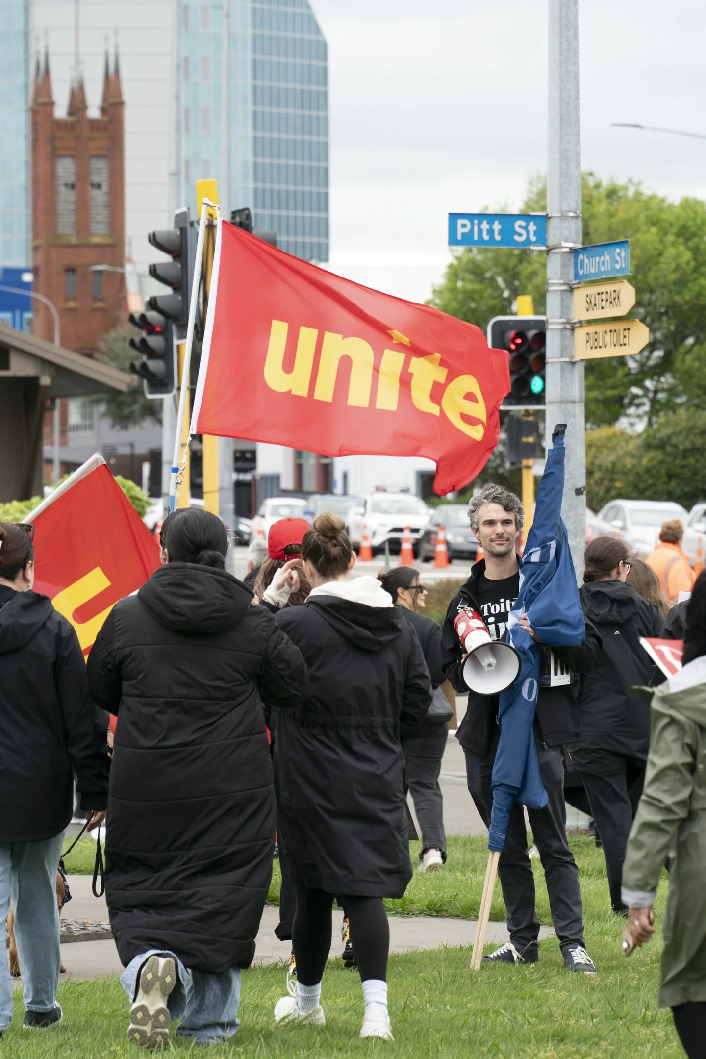 An example of Documentary Photography of protesters marching towards the Palmerston North Square with flags