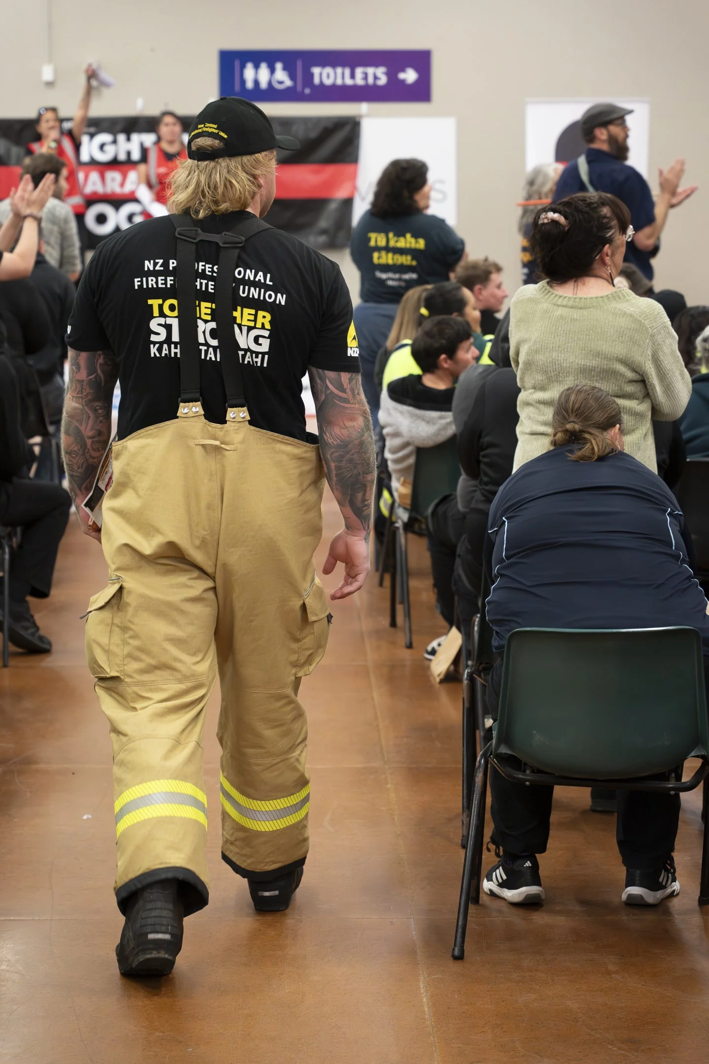 An example of Documentary Photography of a Fireman approaching the stage at a Mayday event in Palmerston North
