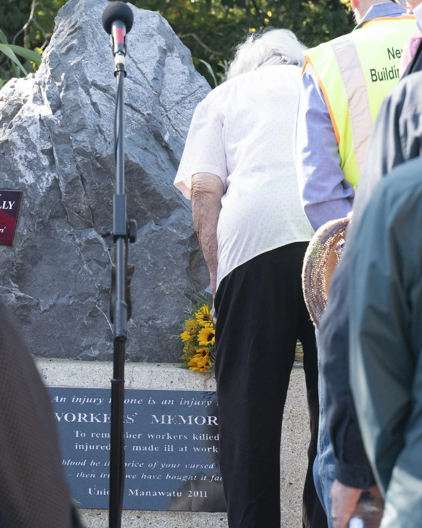 An example of Documentary Photography of an elderly lady paying respects at Workers Memorial Day in Palmerston North