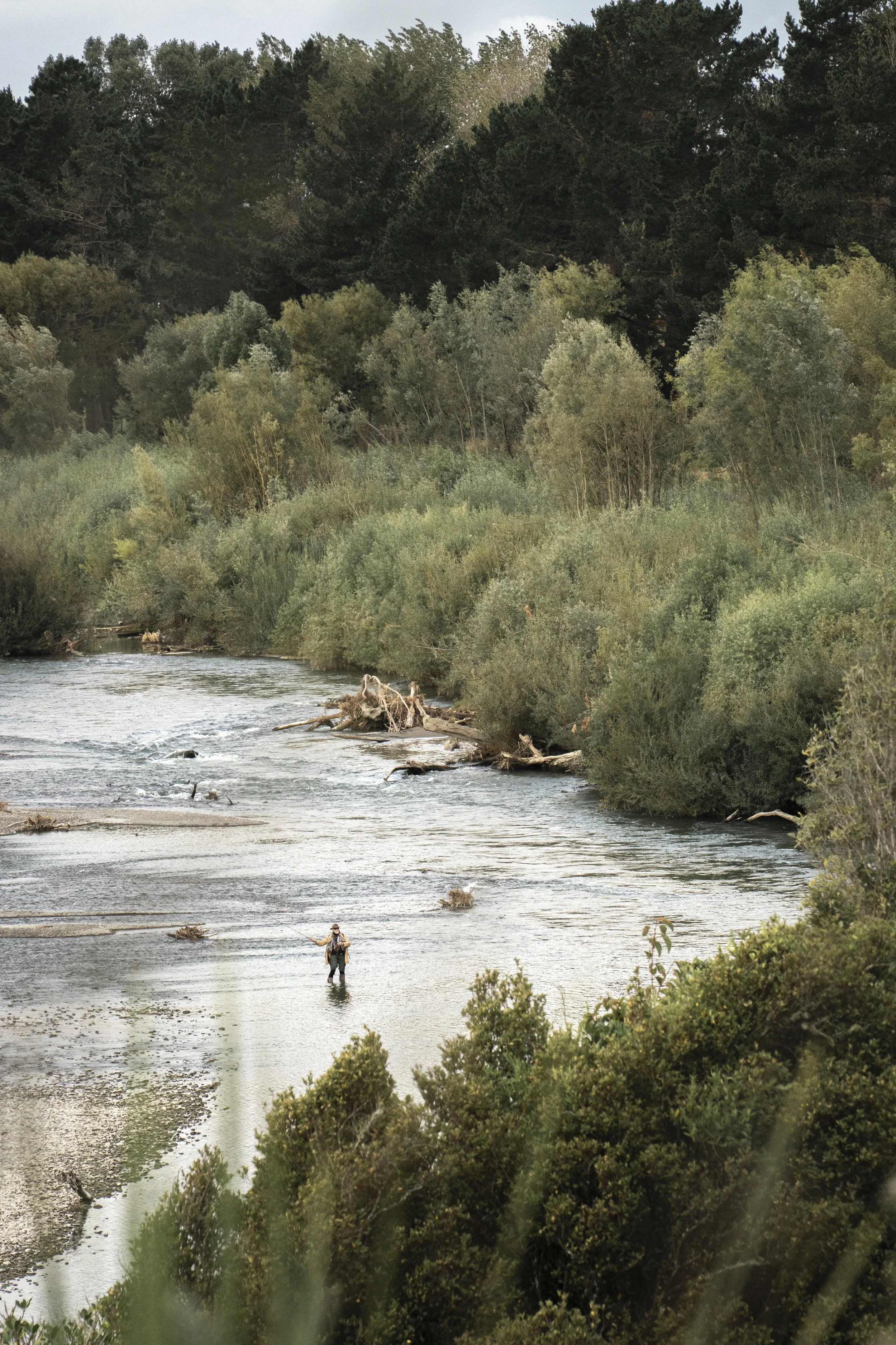 An example of Slice of Life Photography of a fisherman in the Manawatu River