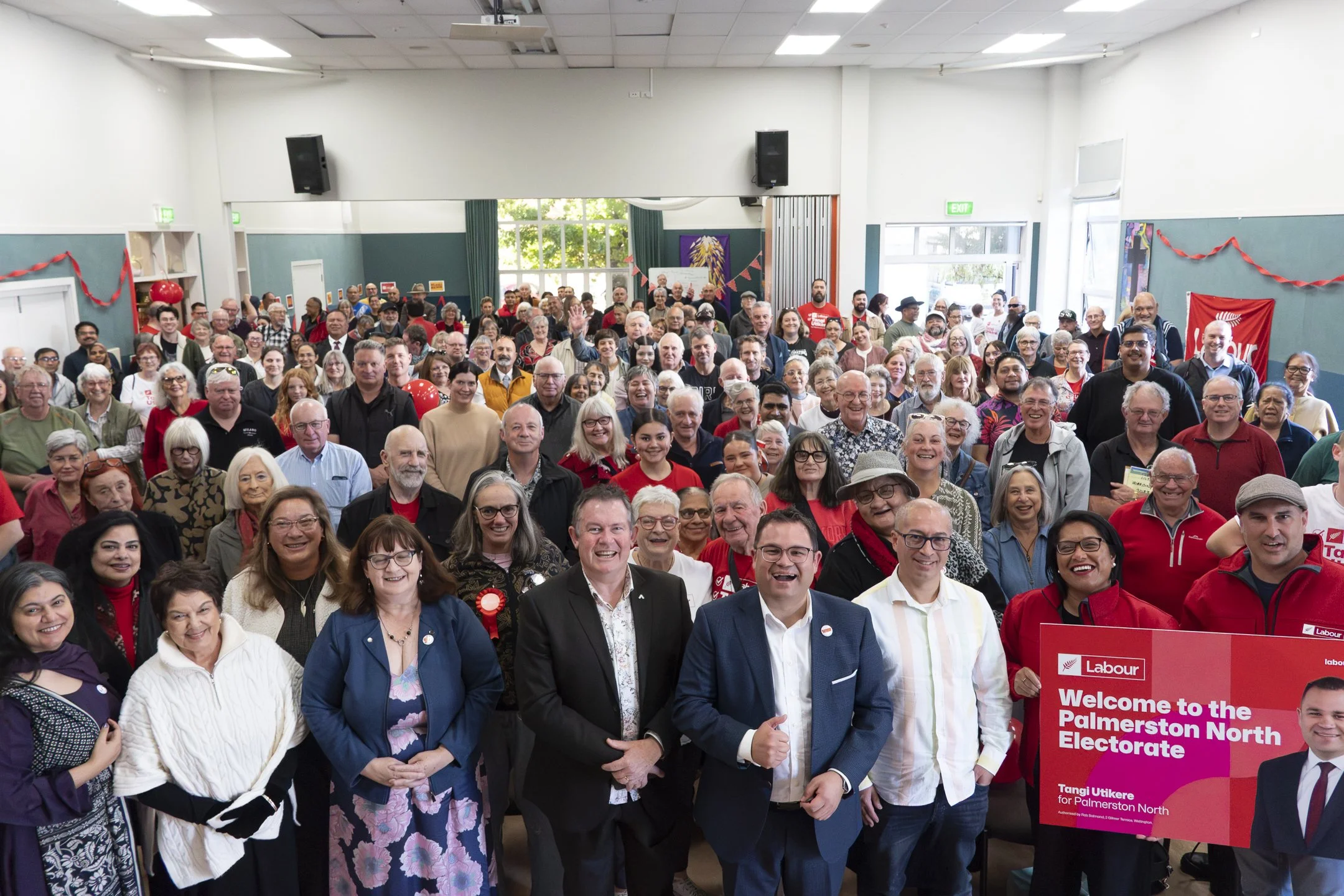 An example of Event Photography of the audience in a group photo pose at the Tangi Utikere Labour Campaign Launch