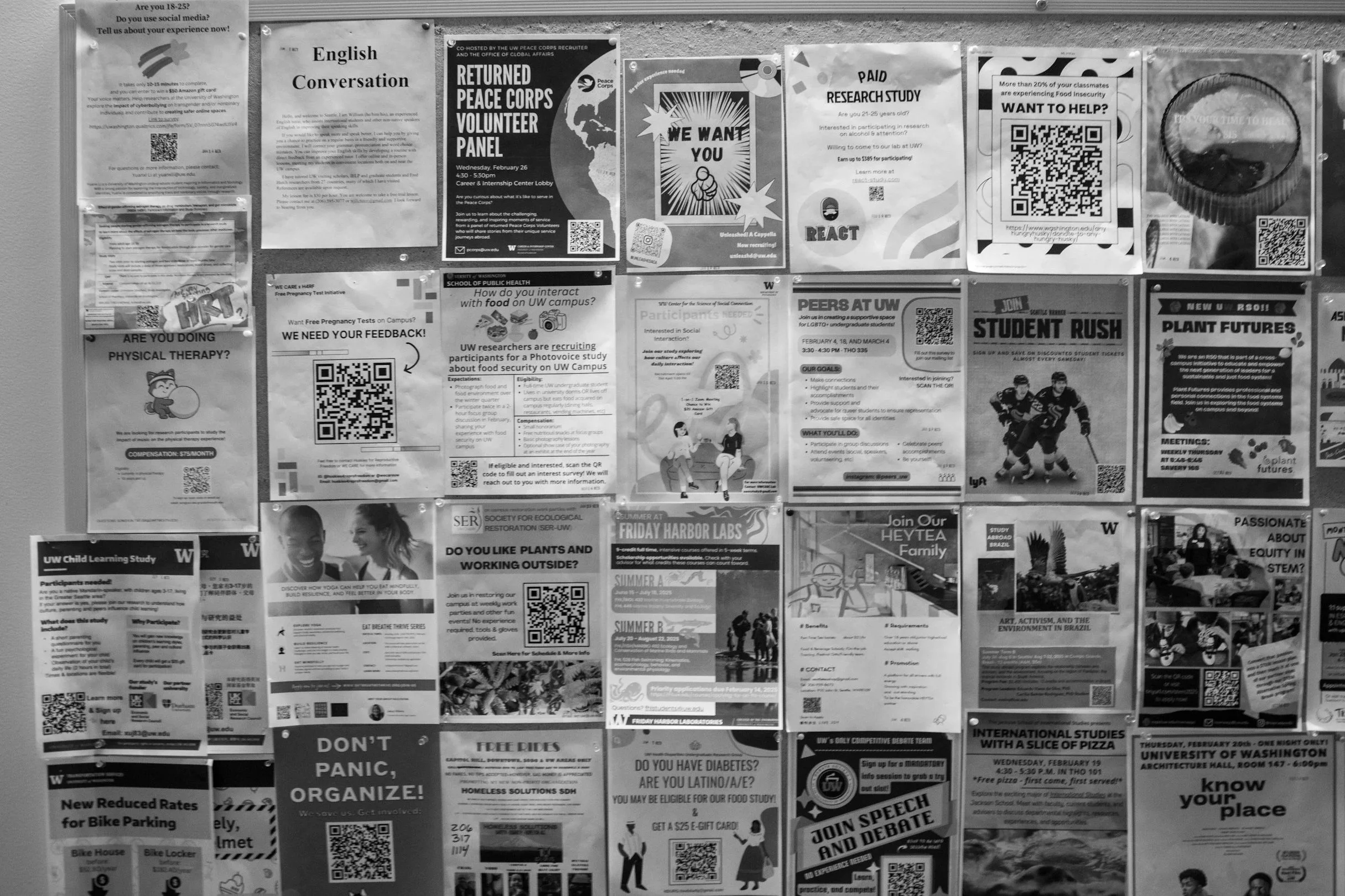 A bulletin board with various posters and flyers related to community activities, student programs, research studies, and social events at the University of Washington.