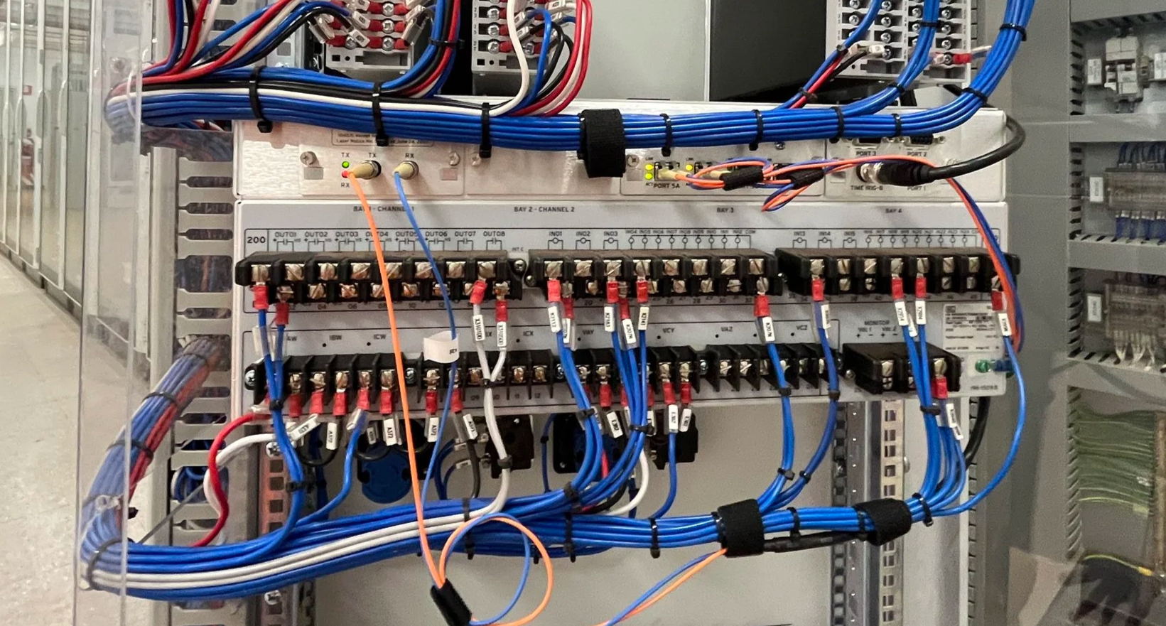 Electrical control panel with interconnected wiring, circuit boards, and terminal blocks inside a metal enclosure.