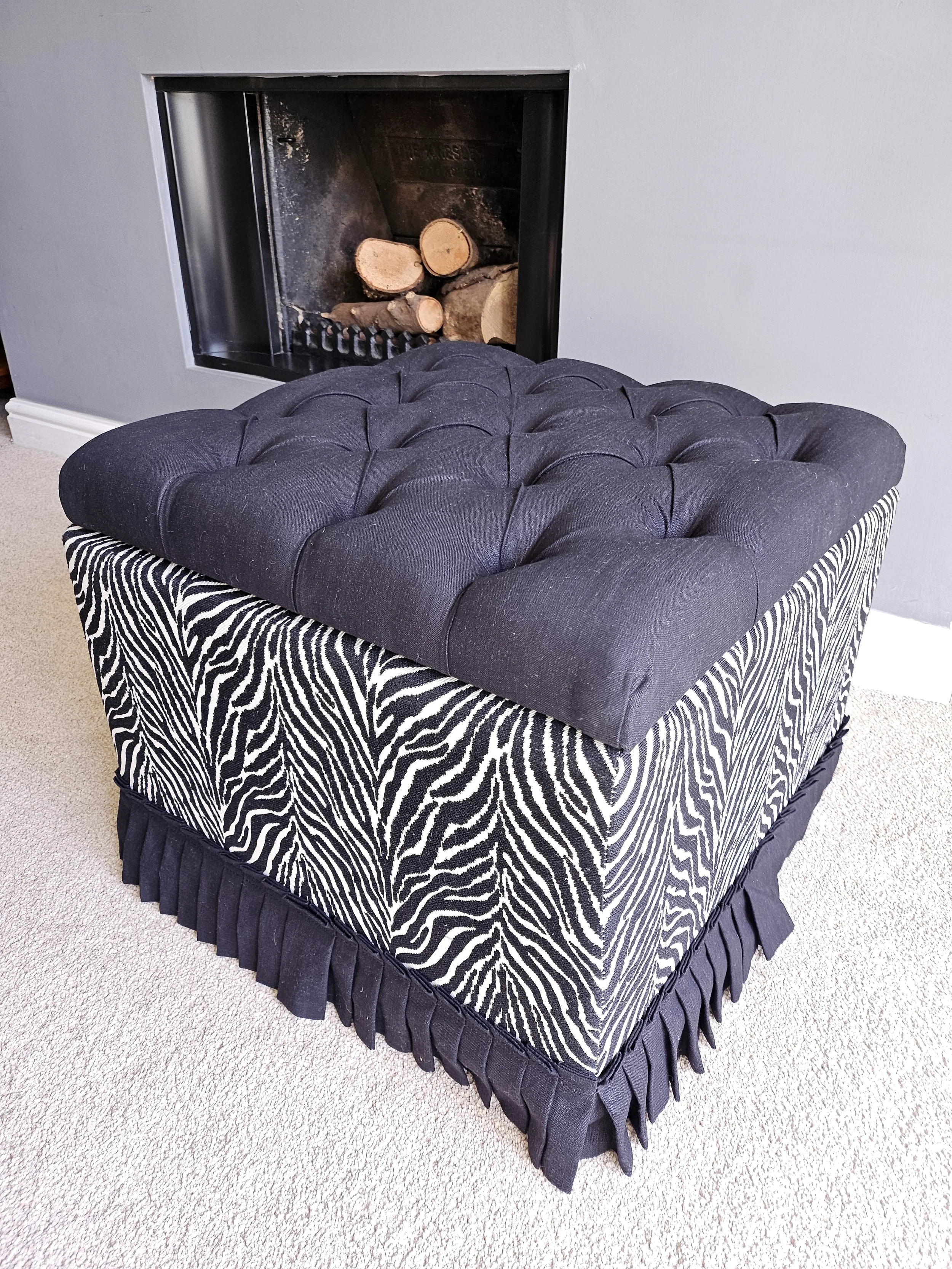 Blanket box with deep buttoned plain black lid and zebra print sides