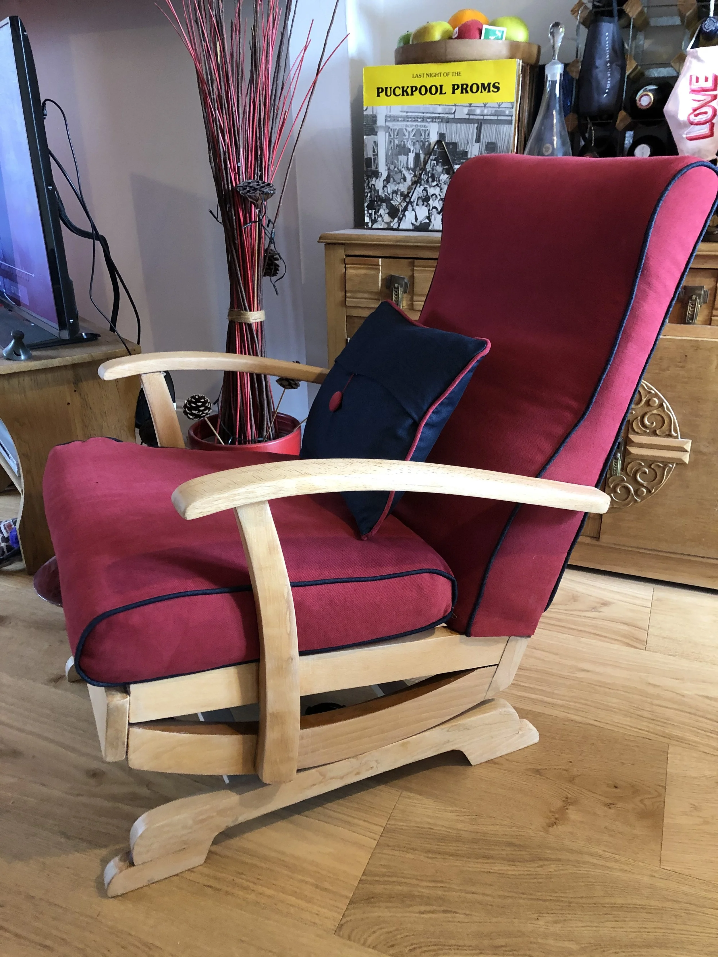 light wood rocking chair with red upholstery and blue piping