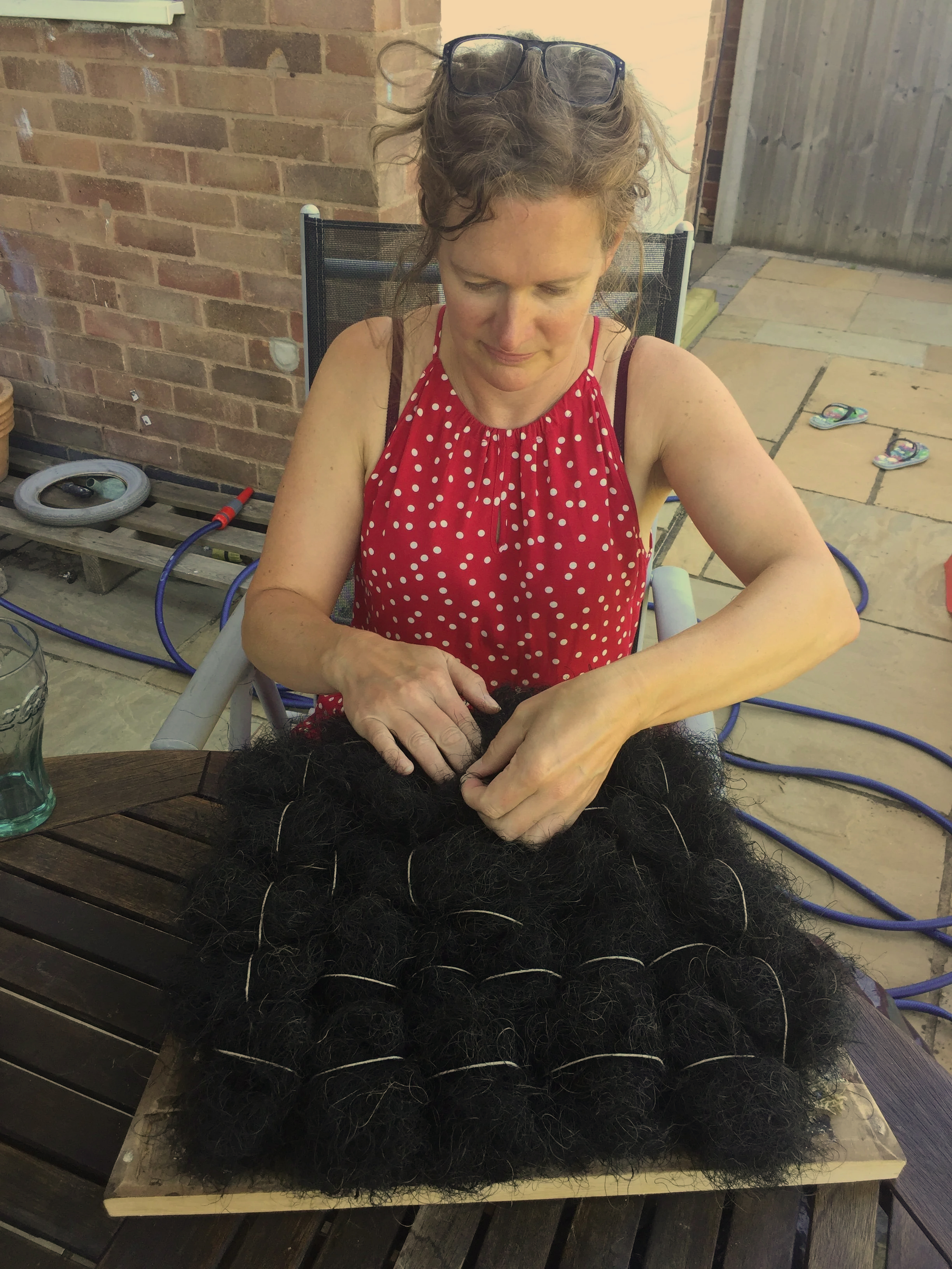 woman attaching horse hair for upholstery
