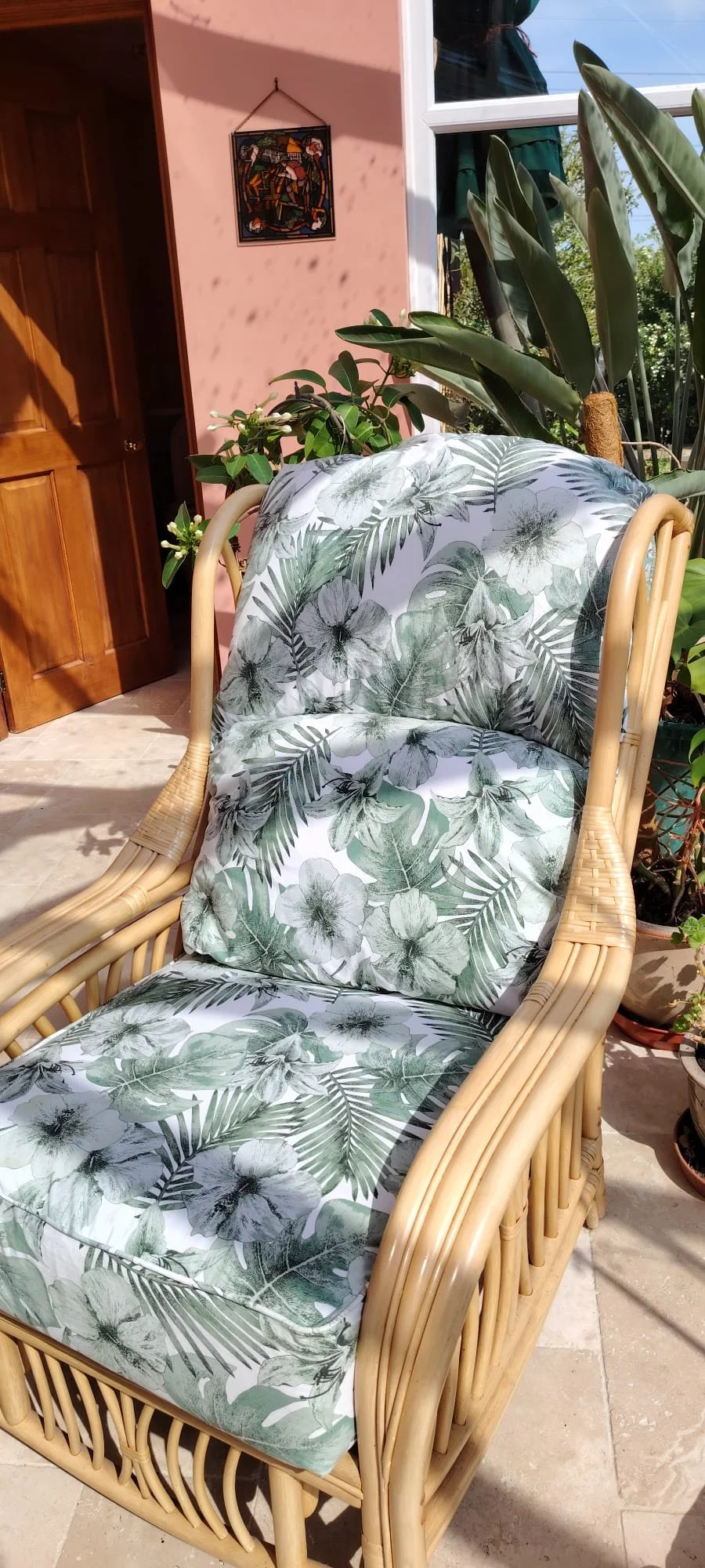 cane chair with green floral upholstery