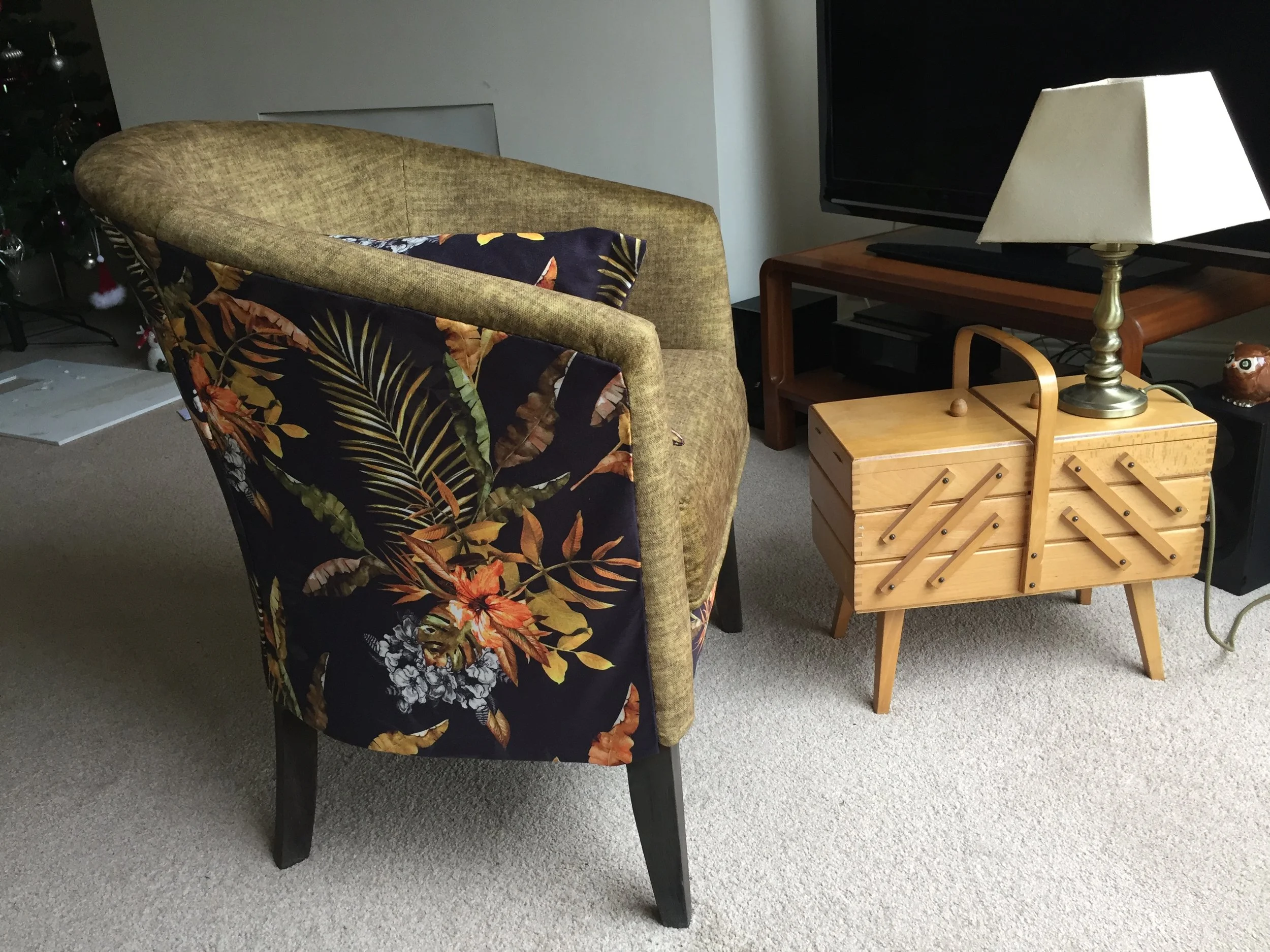 Tub chair in green and autumnal patterned fabric