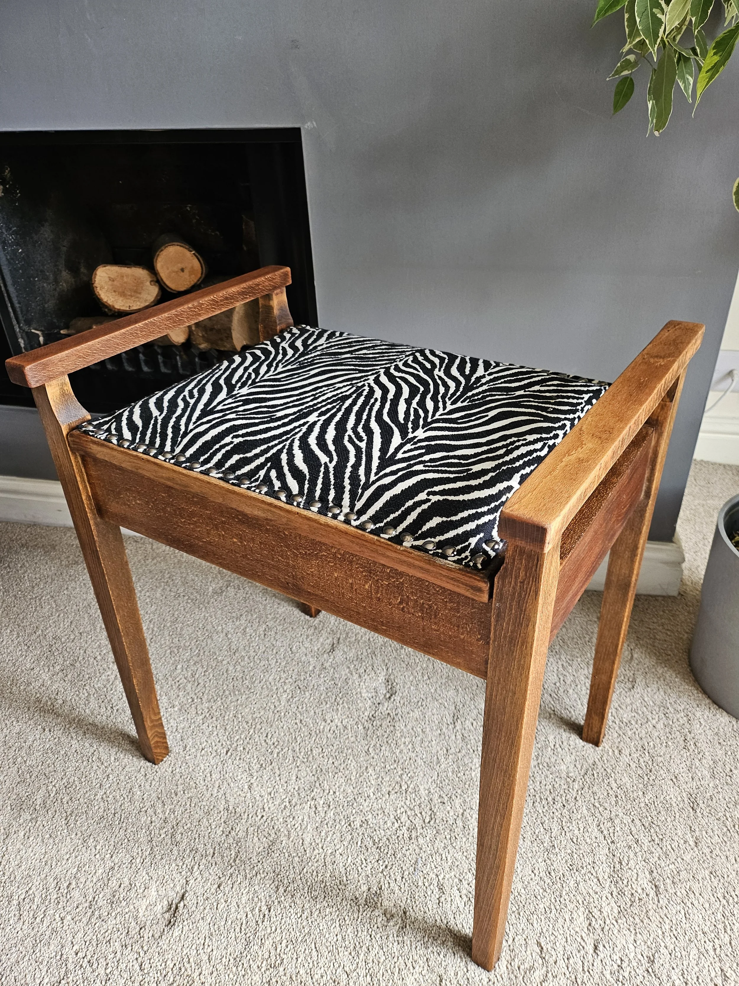 zebra print upholstery on wooden piano stool