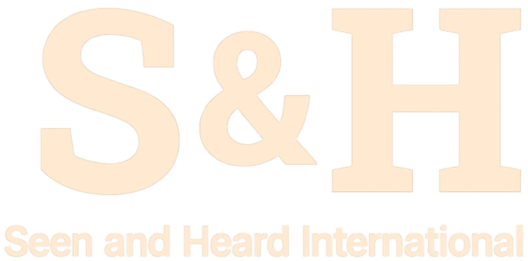 Text logo with large letters '&' between 'S' and 'H', and smaller text below reading 'Seen and Heard International'.