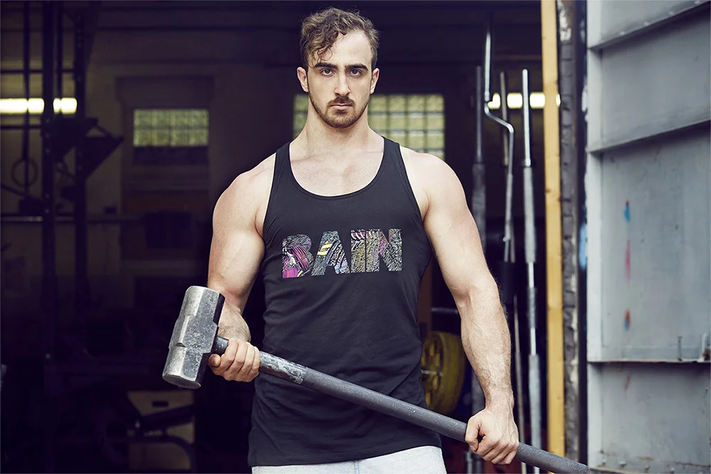 A young man in a black tank top with 