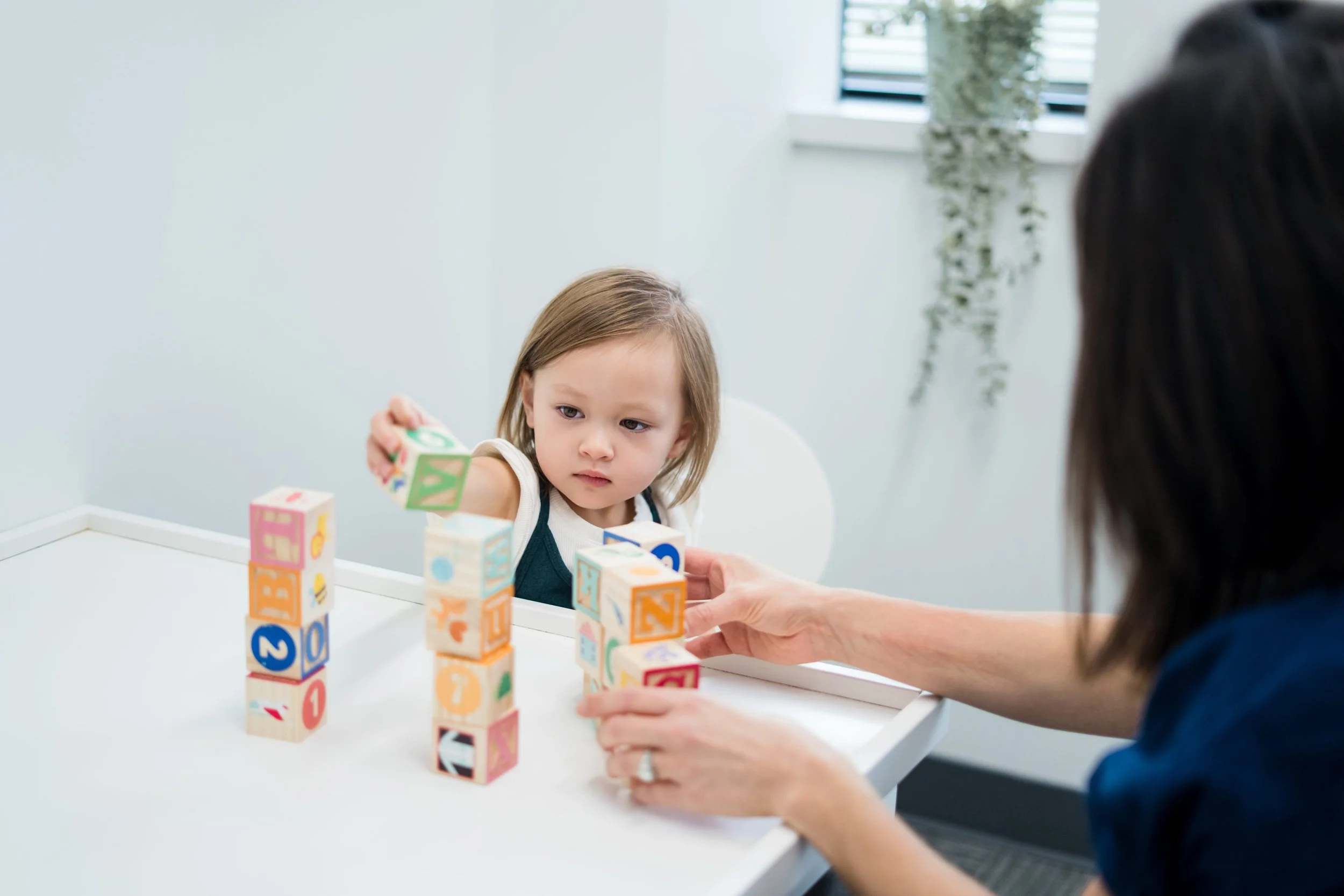 Young child completing an evaluation with a psychologist