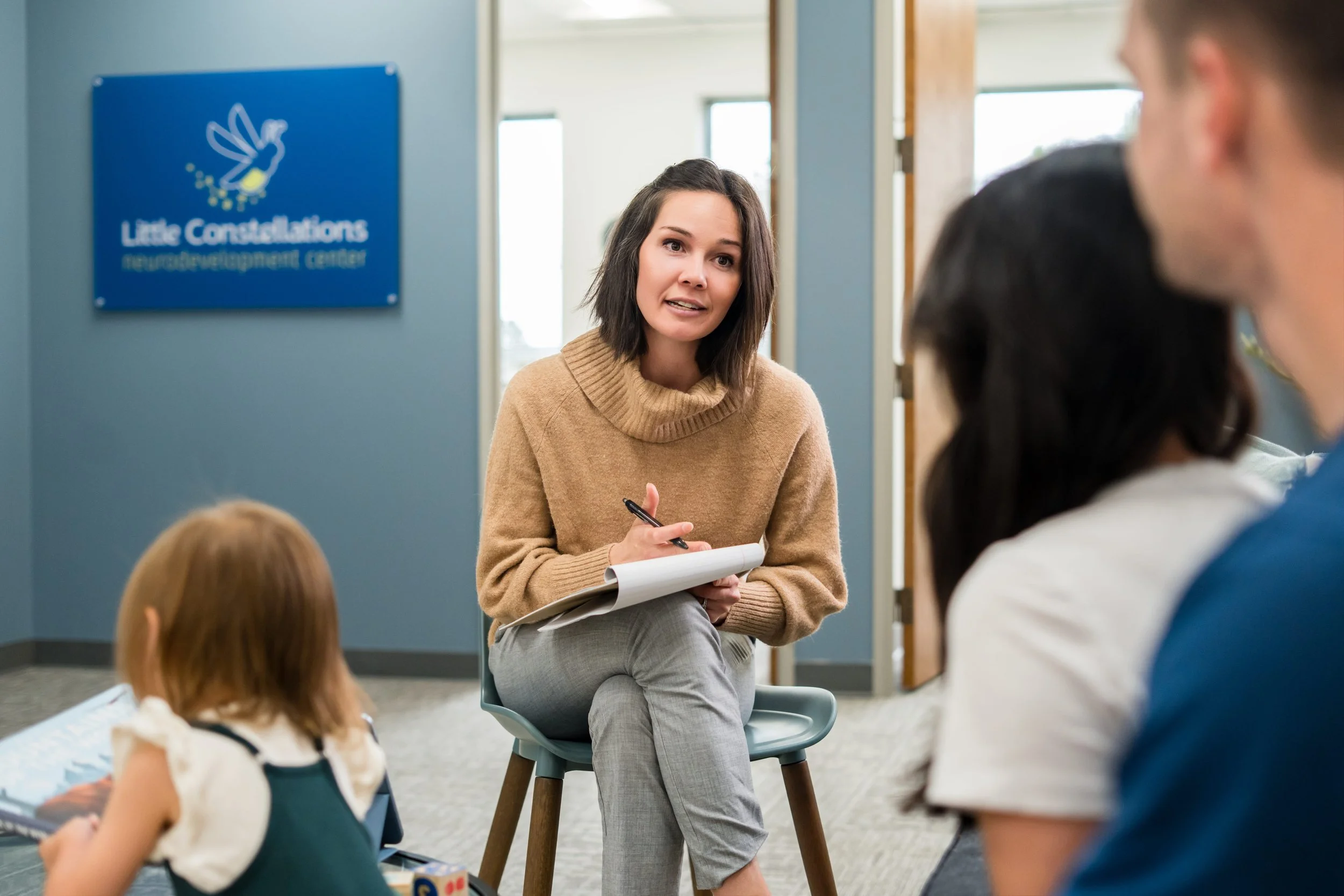 Psychologist speaking with a parent and child during an evaluation
