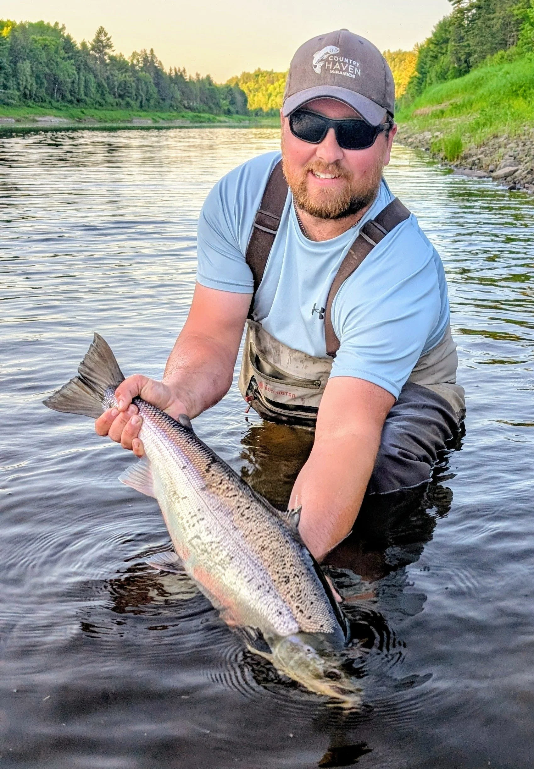 Tyler Coughlan with a large Atlantic Salmon from the Miramichi River and Country Haven Hat.