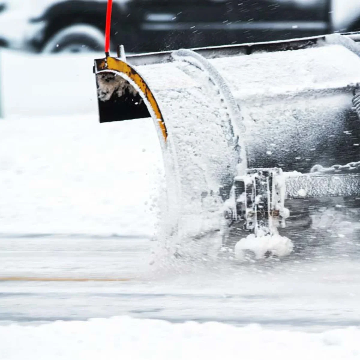 Snowplow clearing snow from a roadway during winter
