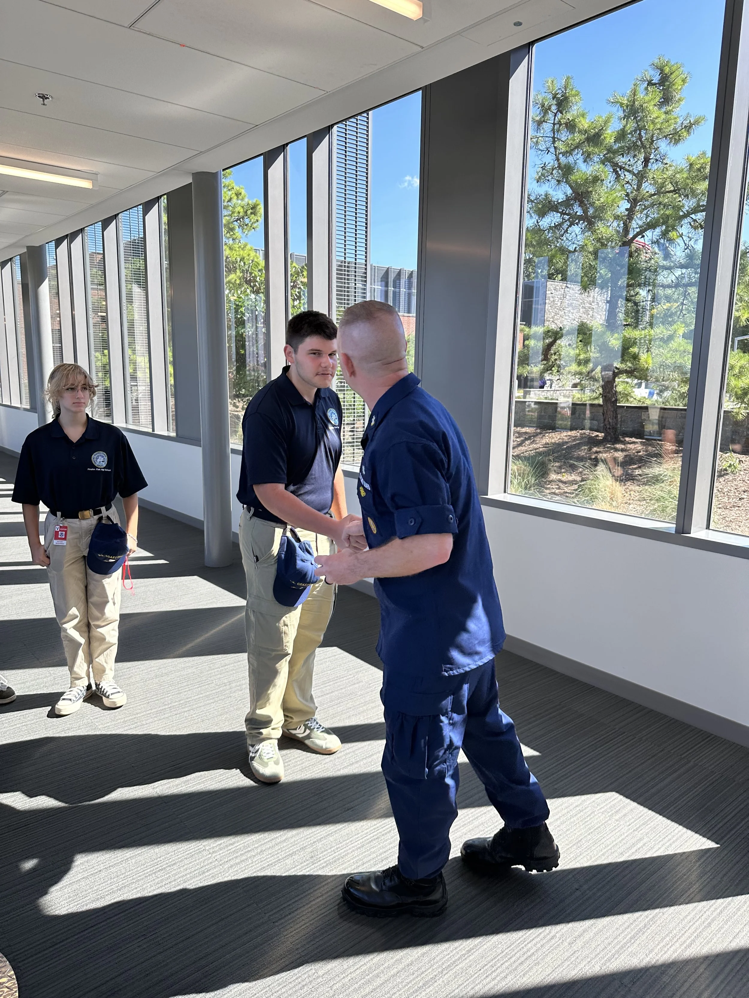 Ensign Foley shaking the hand of MCPOCG Phil Waldron.