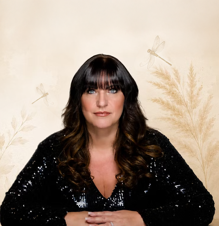 A woman with long, wavy dark hair and bangs, wearing a black sequined top, sitting with her hands crossed on a table, against a beige background with illustrations of dragonflies and plants.