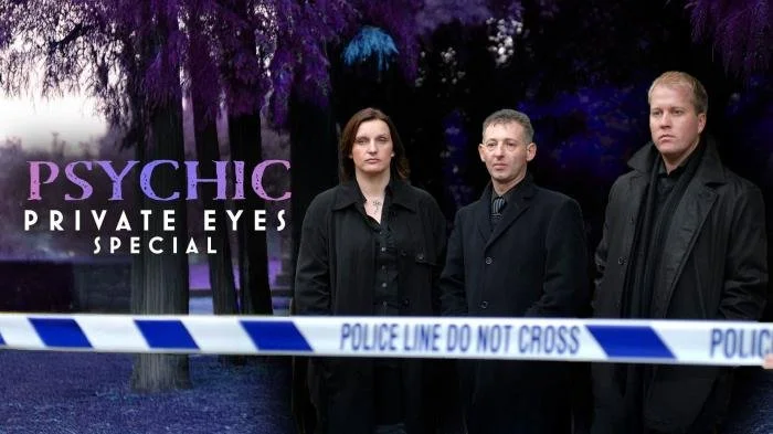 Three people standing behind police tape with a sign reading 'Psychic Private Eyes Special' in a wooded area during twilight.