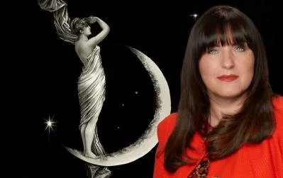 A woman with dark hair and bangs wearing a red top, standing in front of a black background with a decorative moon and star illustration.