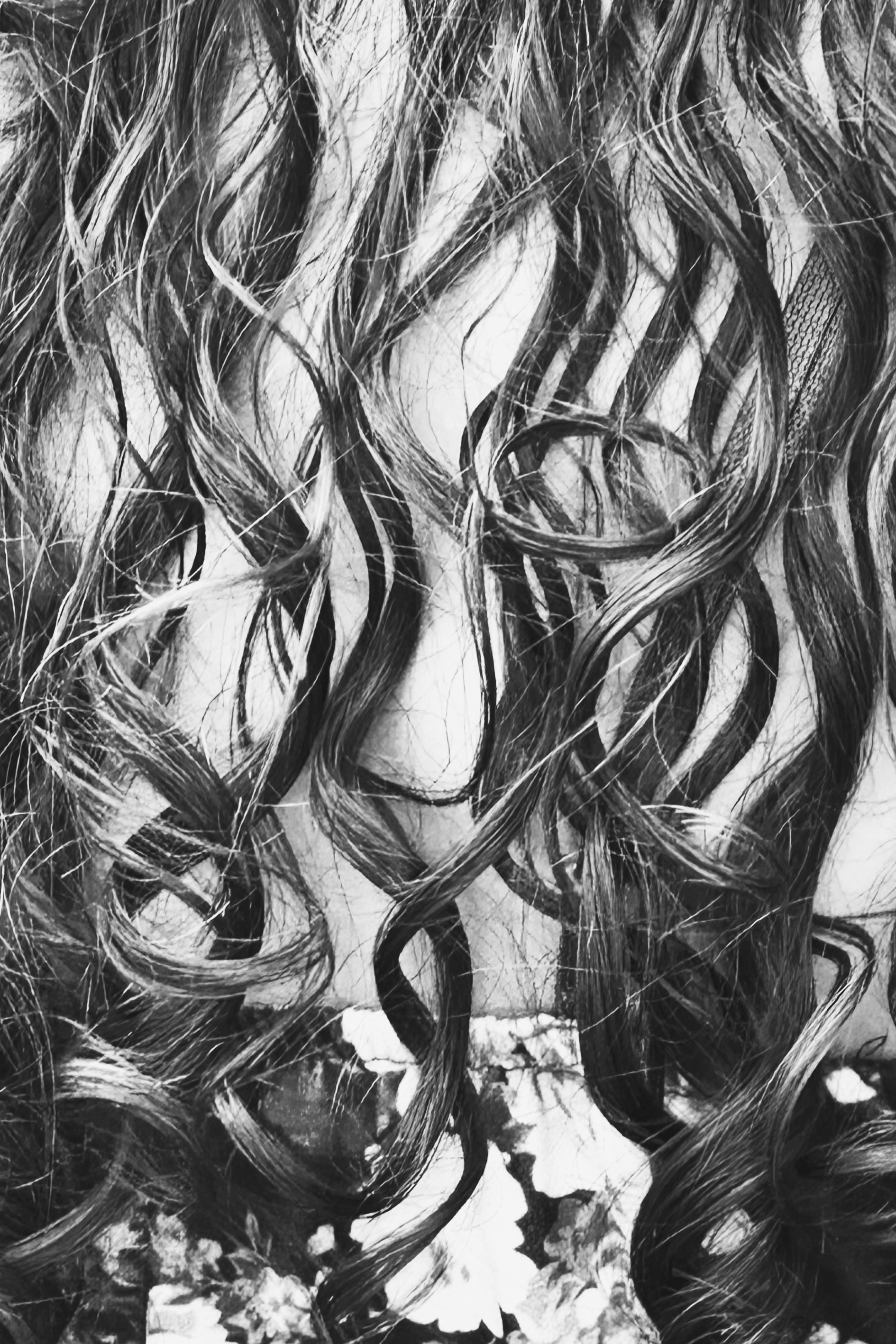 Abstract black and white drawing of a woman's face with long flowing hair.