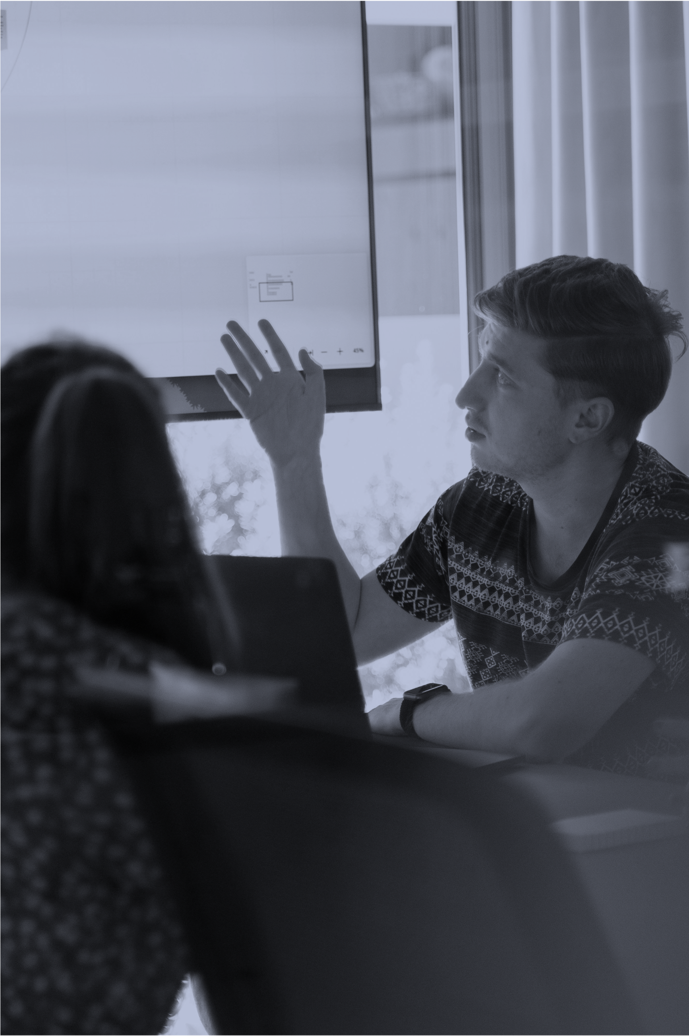 Workshop participant pointing to a projected screen