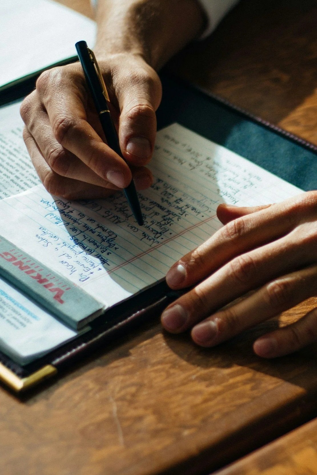Person taking notes in a notebook