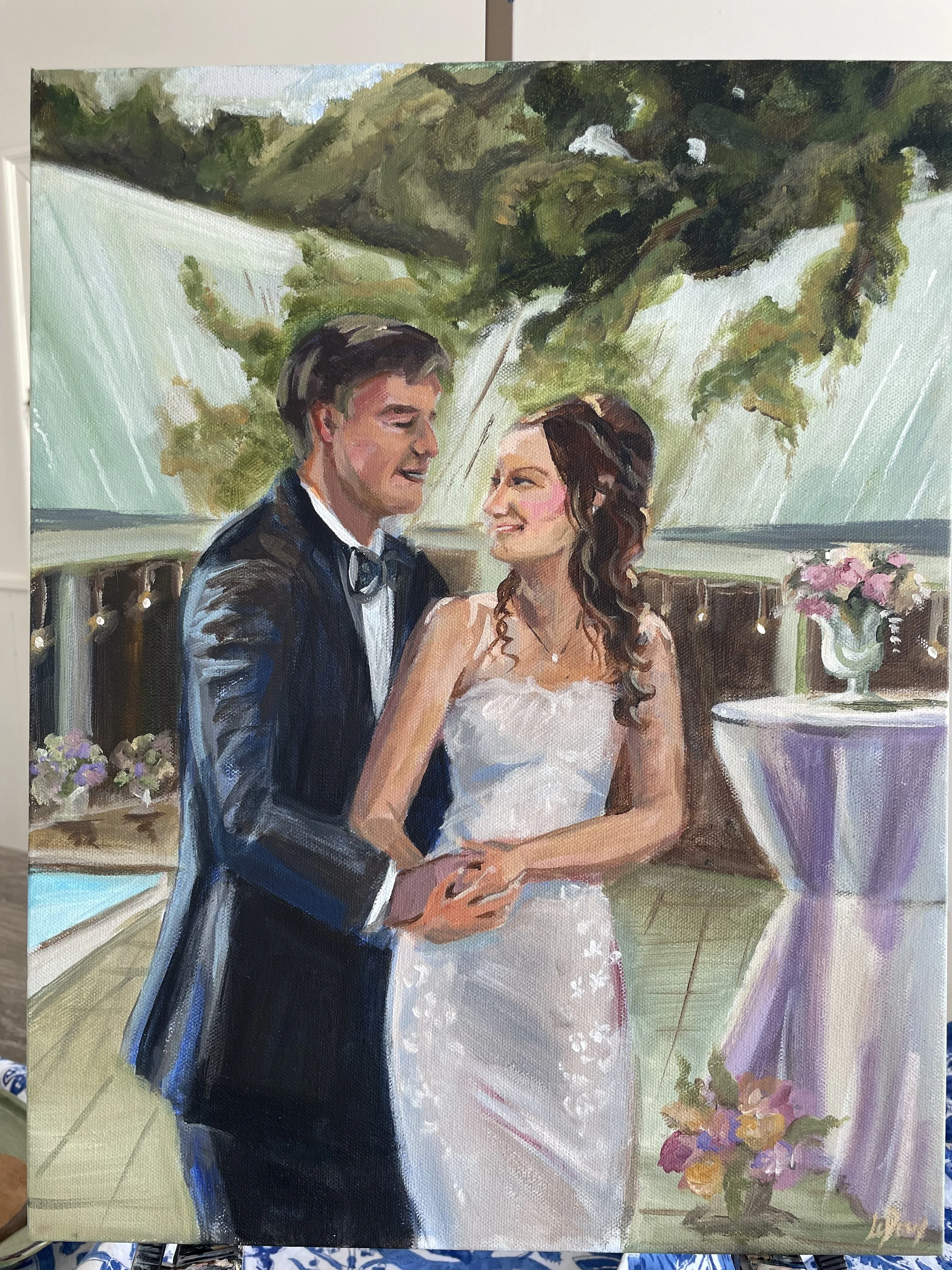 A watercolor painting of a bride and groom sharing their first dance, with the groom in a tuxedo and the bride in a white strapless wedding gown, surrounded by flowers and greenery.