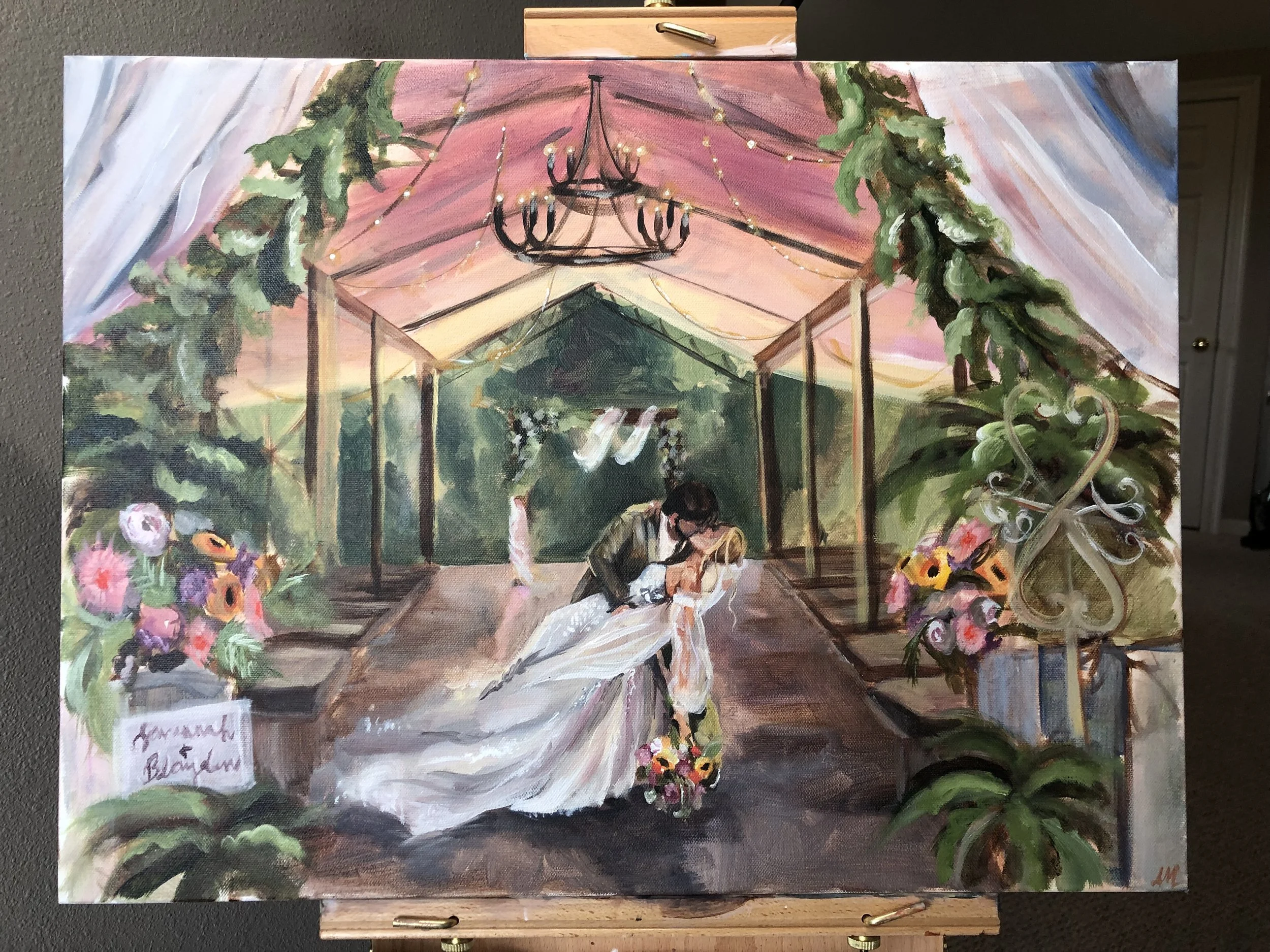 A colorful painting of a wedding scene under a canopy decorated with flowers and greenery. The painting depicts an outdoor setting with string lights and a chandelier hanging from the canopy. Two people, likely the bride and groom, are sitting at a t