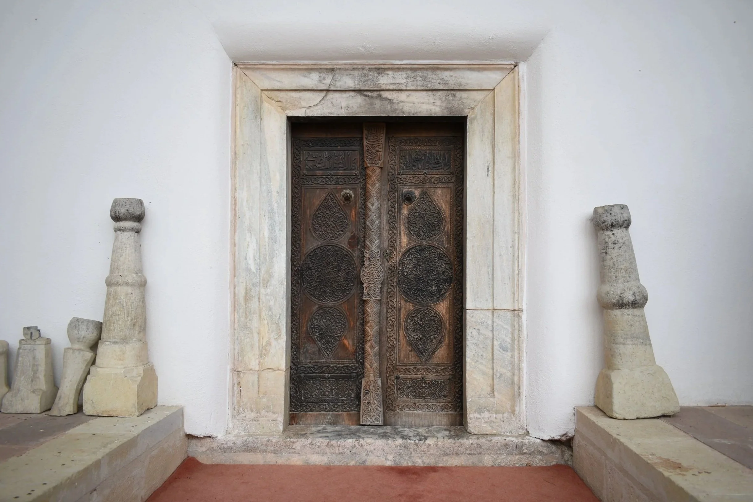 Ancient interior doors framed with marble.