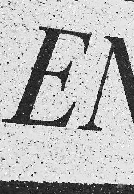 Close-up of a textured surface with the partial letter 'E' visible.