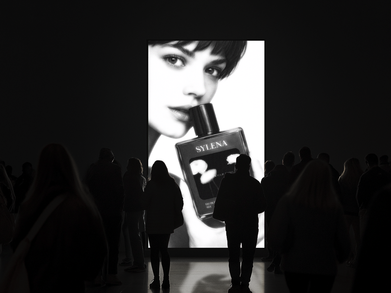 Sylena perfume campaign on a large screen, a model holding the bottle above a gathered crowd