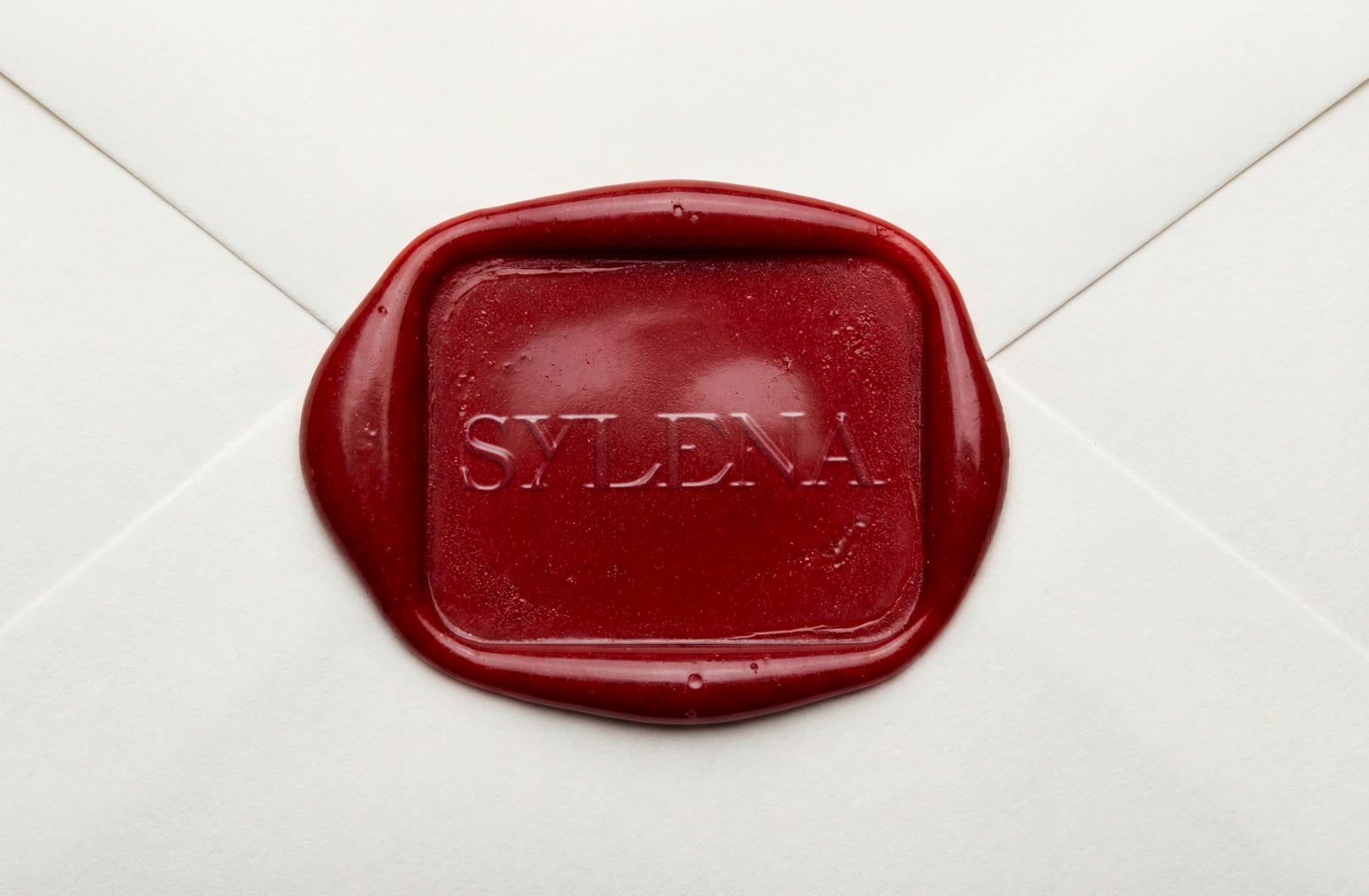 Ivory envelope sealed with a red Sylena wax seal